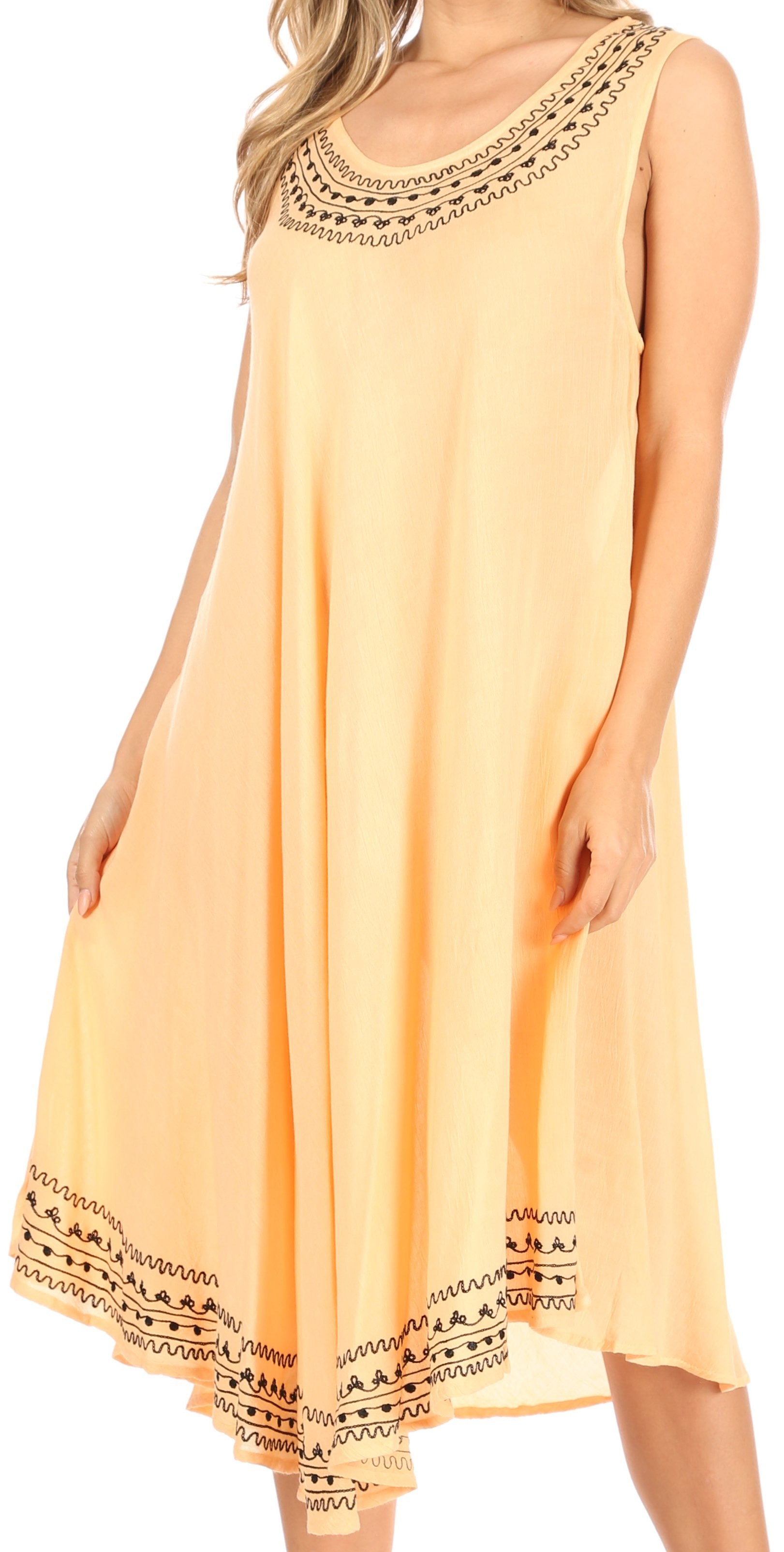 Woman wearing a peach-colored dress with black lace details on a white background