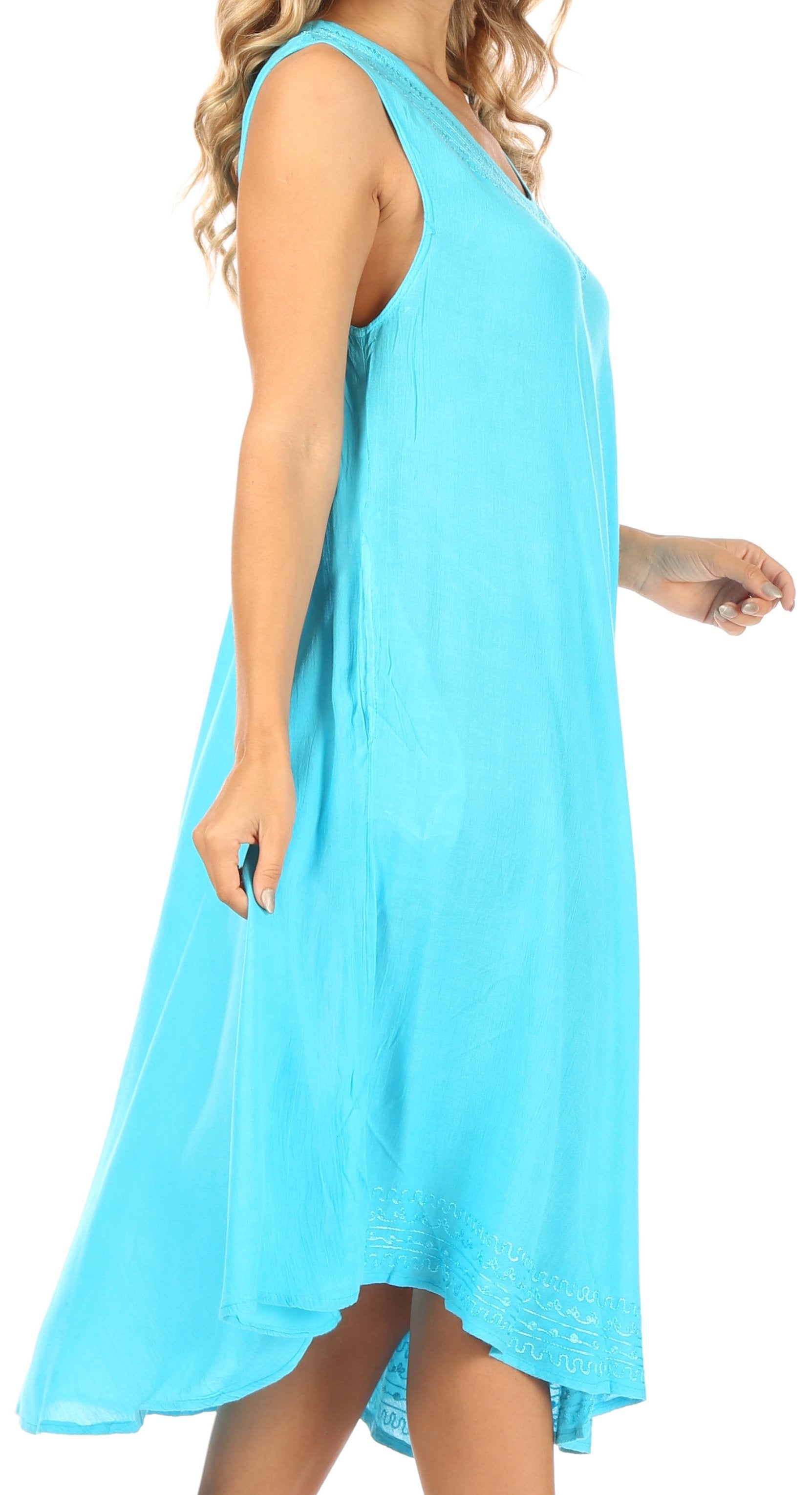 Woman wearing a light blue sleeveless dress on a white background