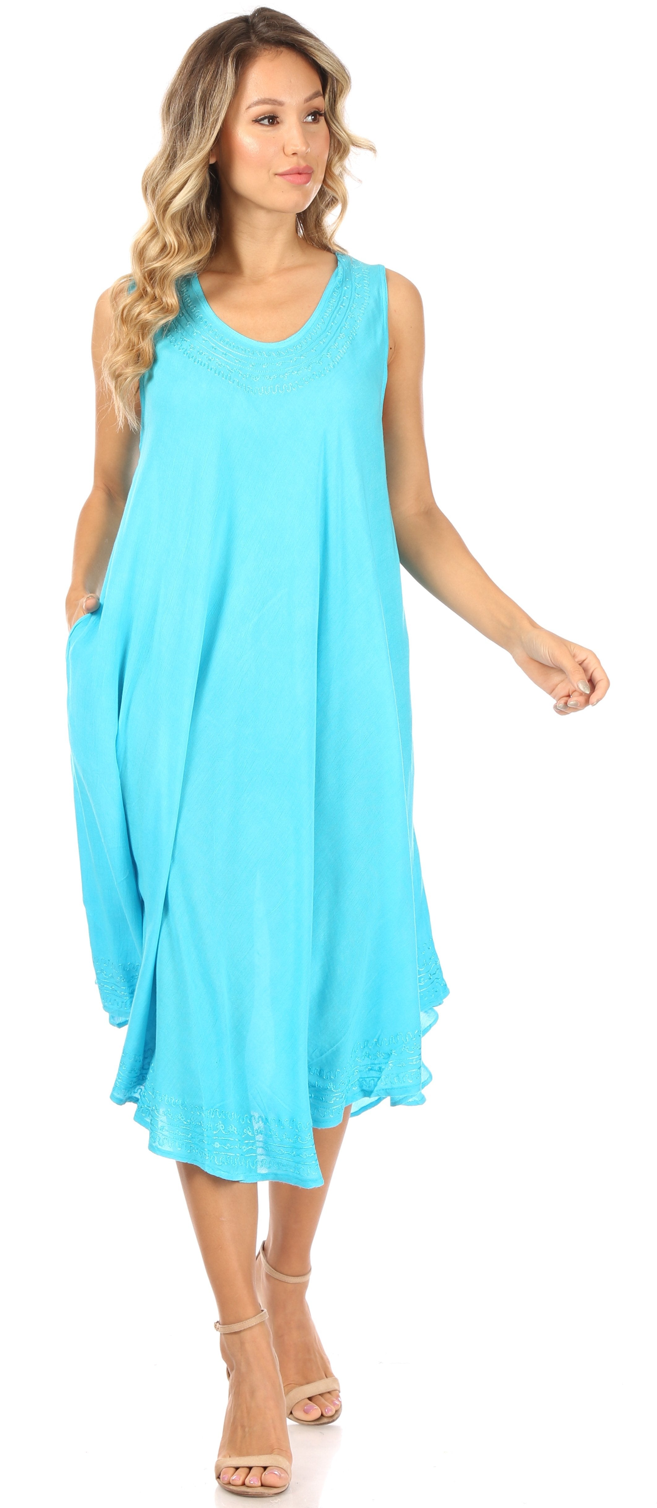 Woman wearing a light blue sleeveless dress on a white background