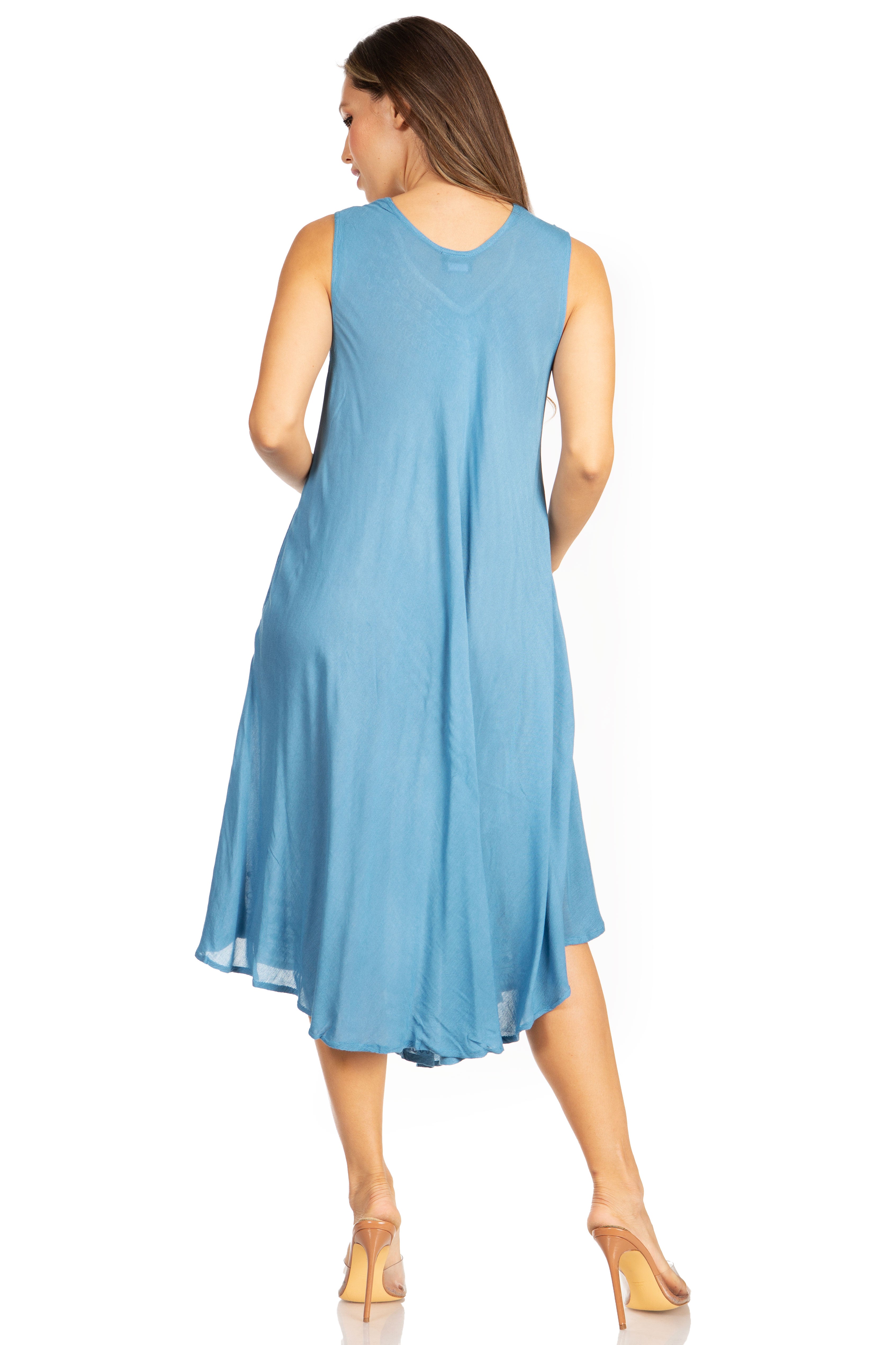 Woman wearing a blue sleeveless dress on a white background