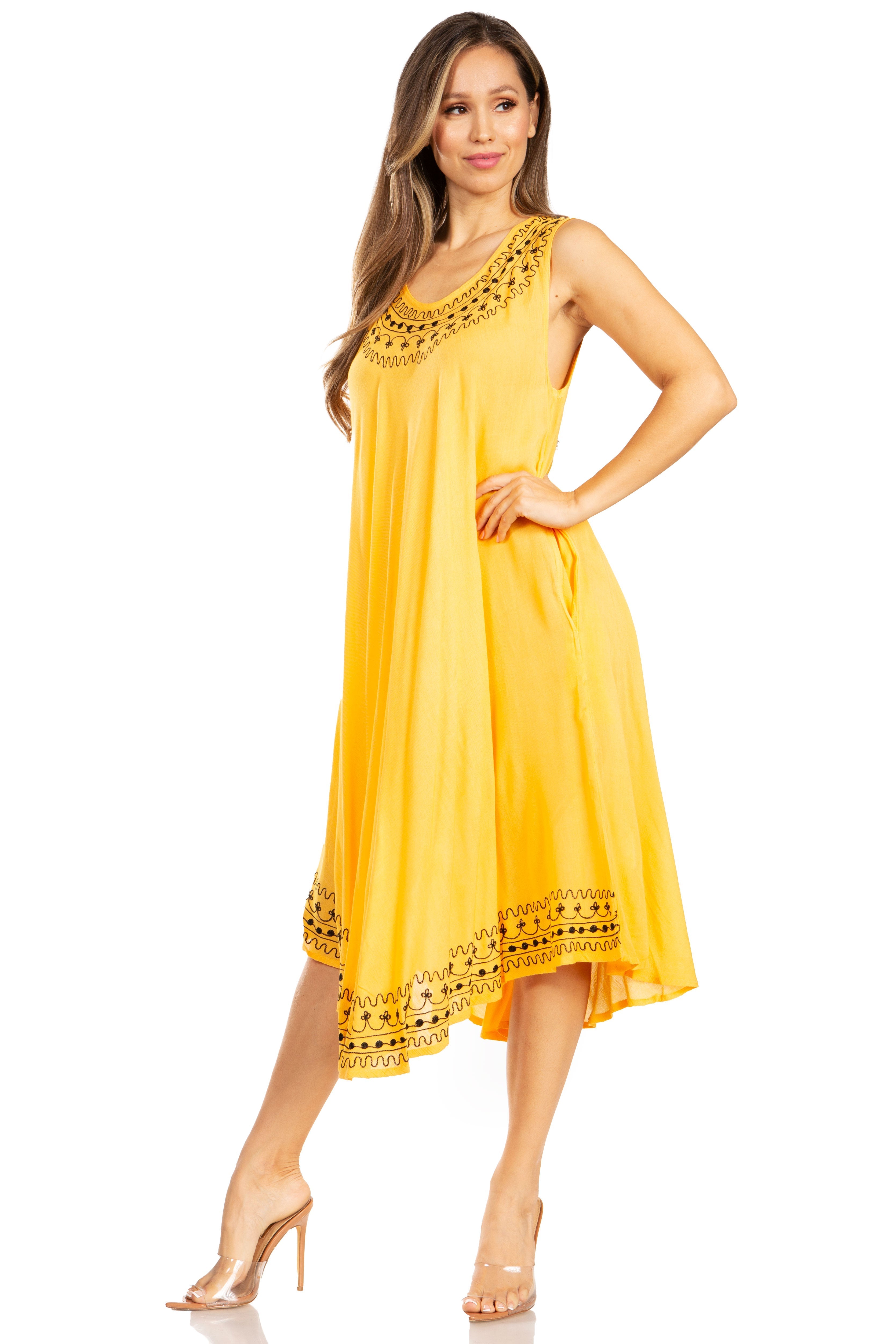 Woman wearing a yellow dress with black lace details on a white background