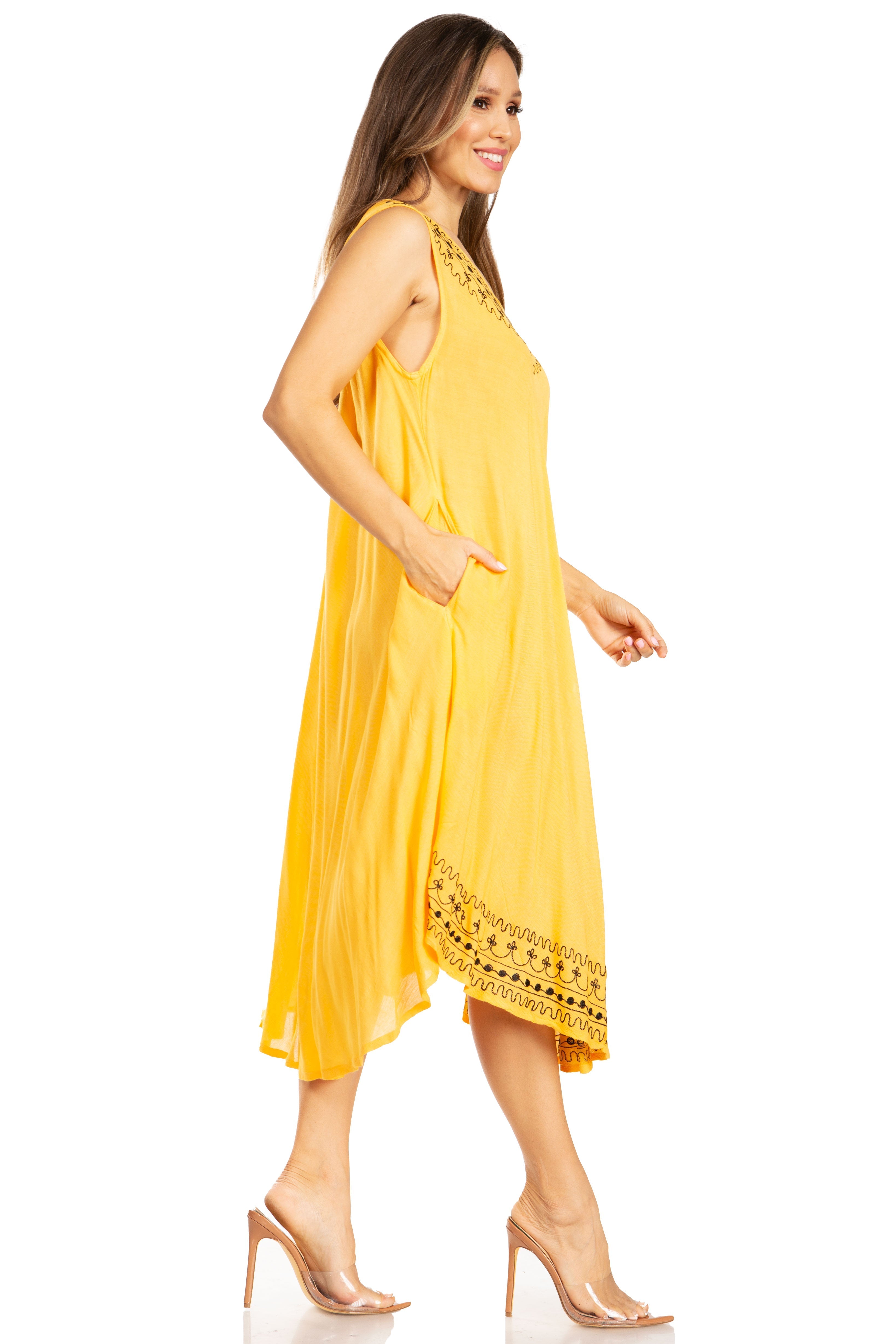 Woman wearing a yellow dress with lace details on a white background