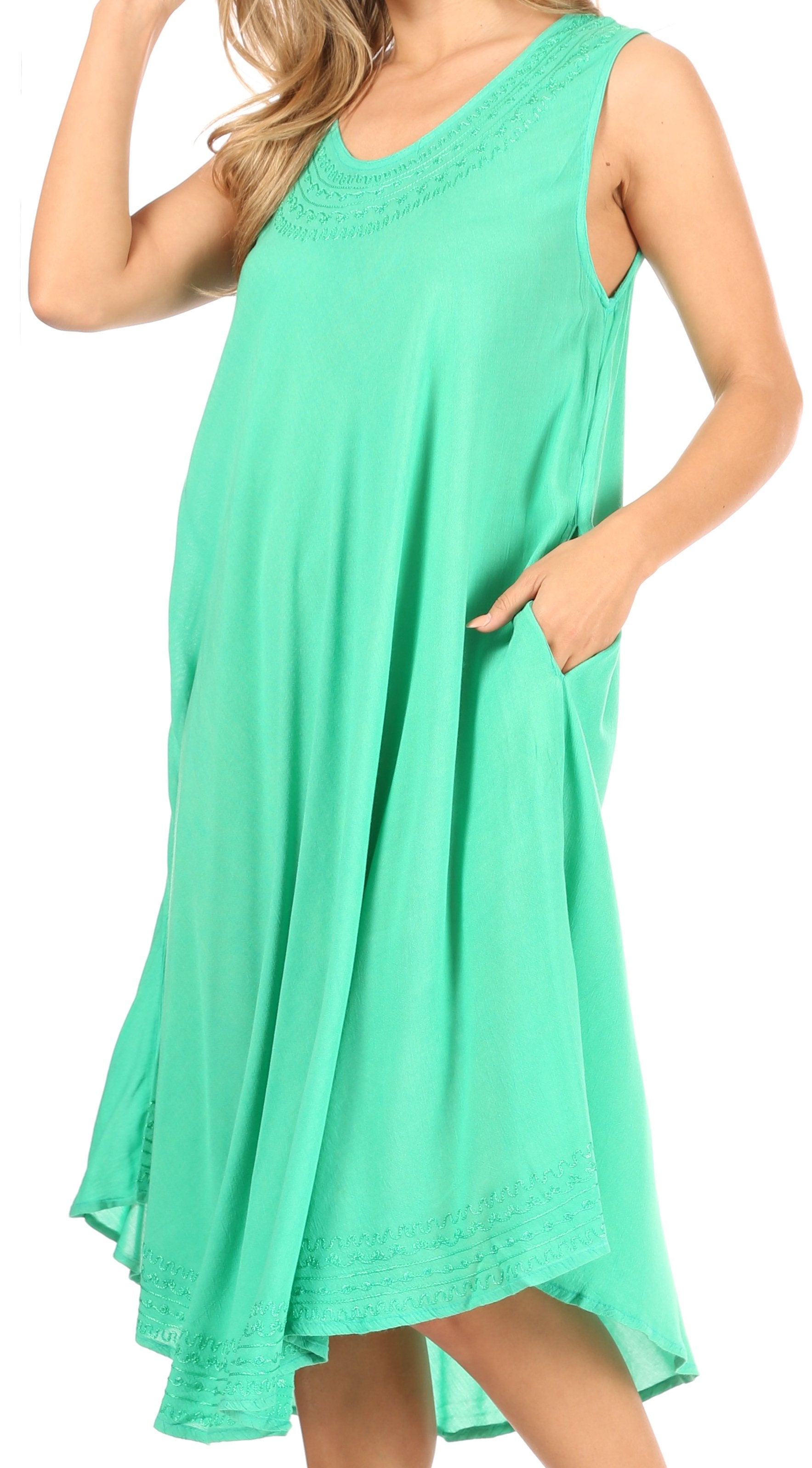 Mint green sleeveless dress worn by a model on a white background