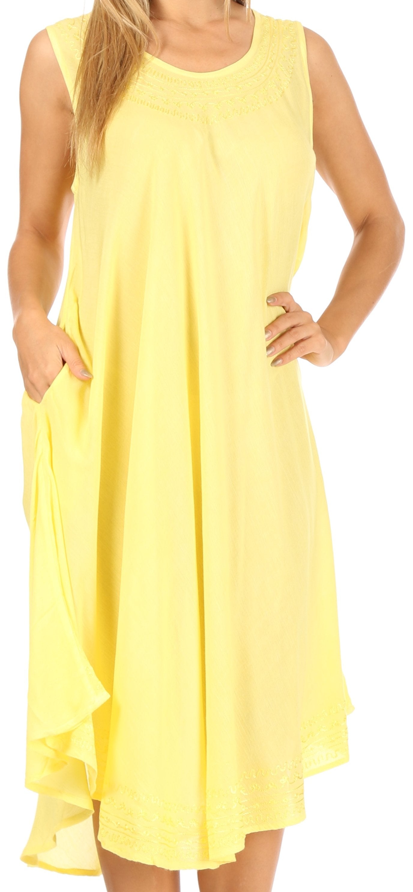 Woman wearing a yellow sleeveless dress with pockets.