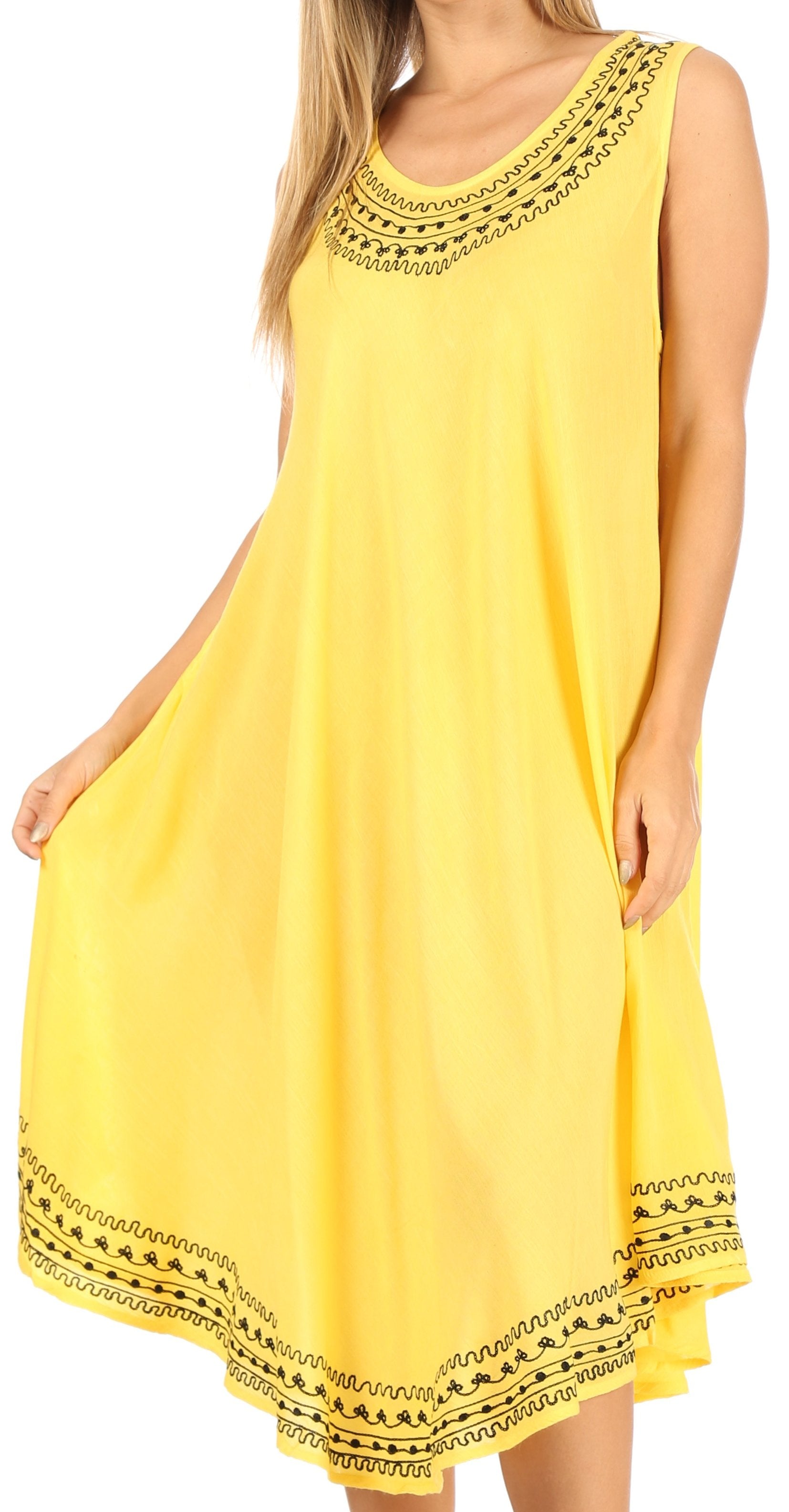 Yellow dress with black lace details on a white background