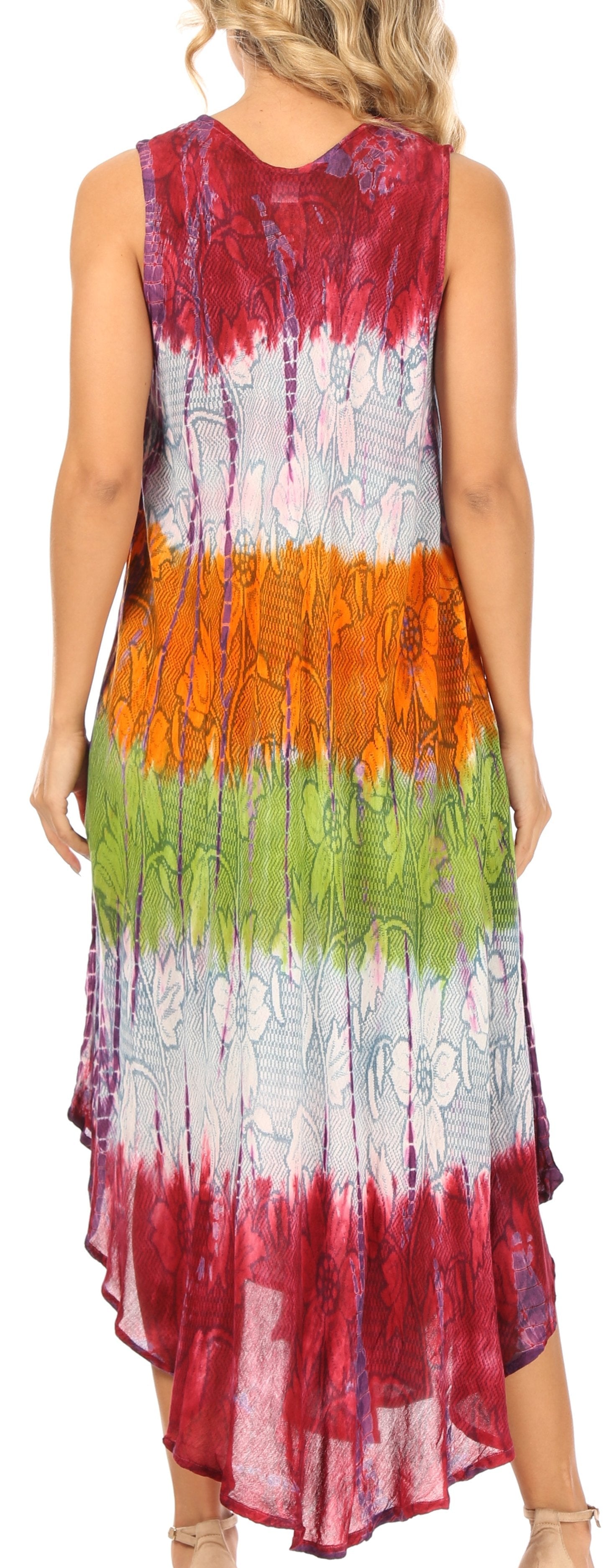 Woman wearing a colorful tie-dye dress with a gradient of red, orange, green, and white.