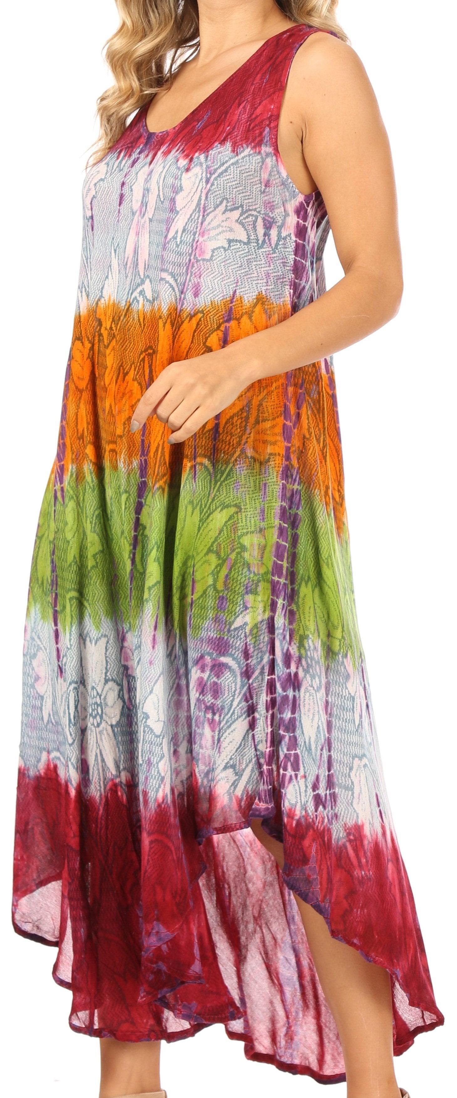 Woman wearing a colorful tie-dye dress with a gradient from red to green.