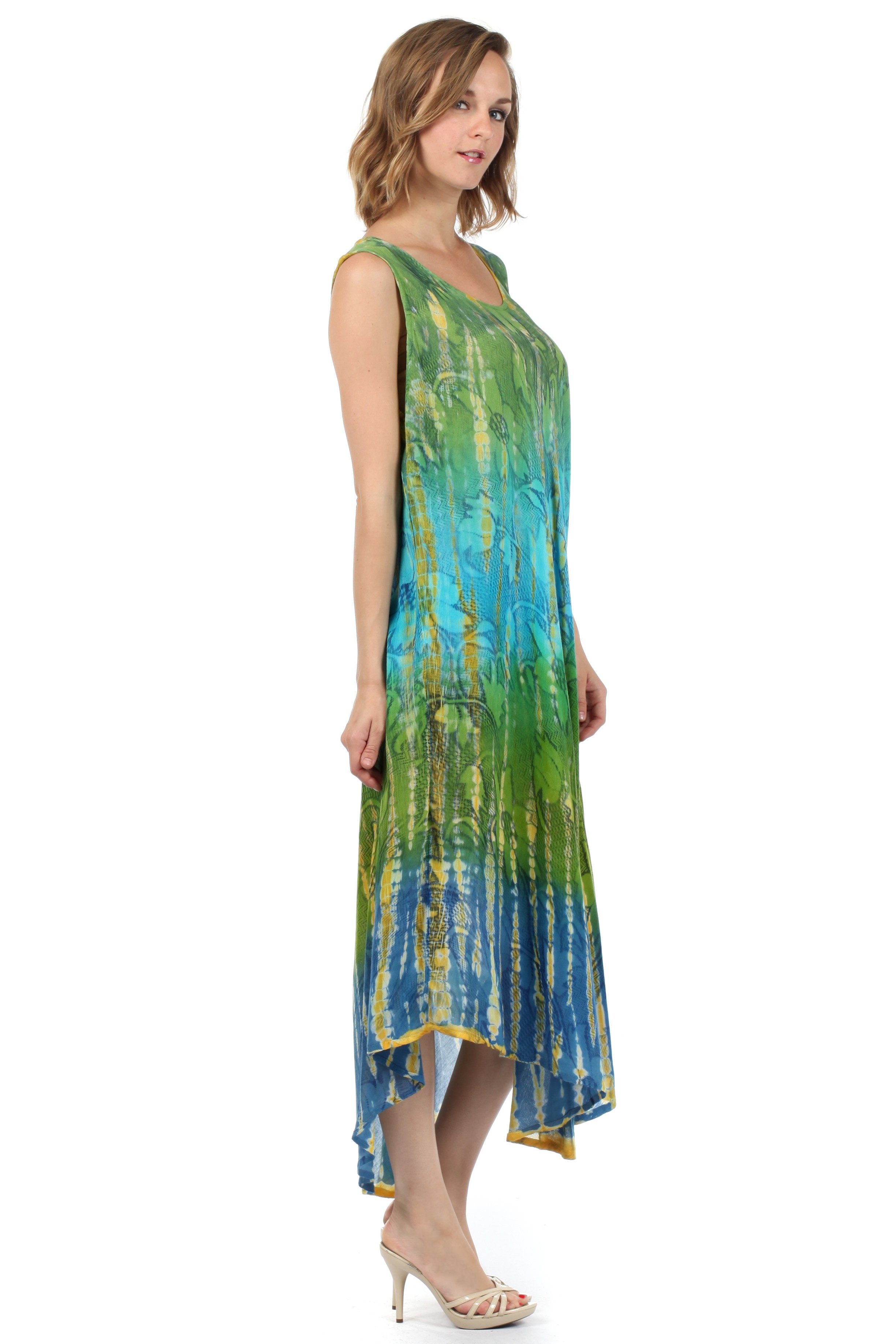 Woman wearing a tie-dye dress with a gradient of green, blue, and yellow on a white background.