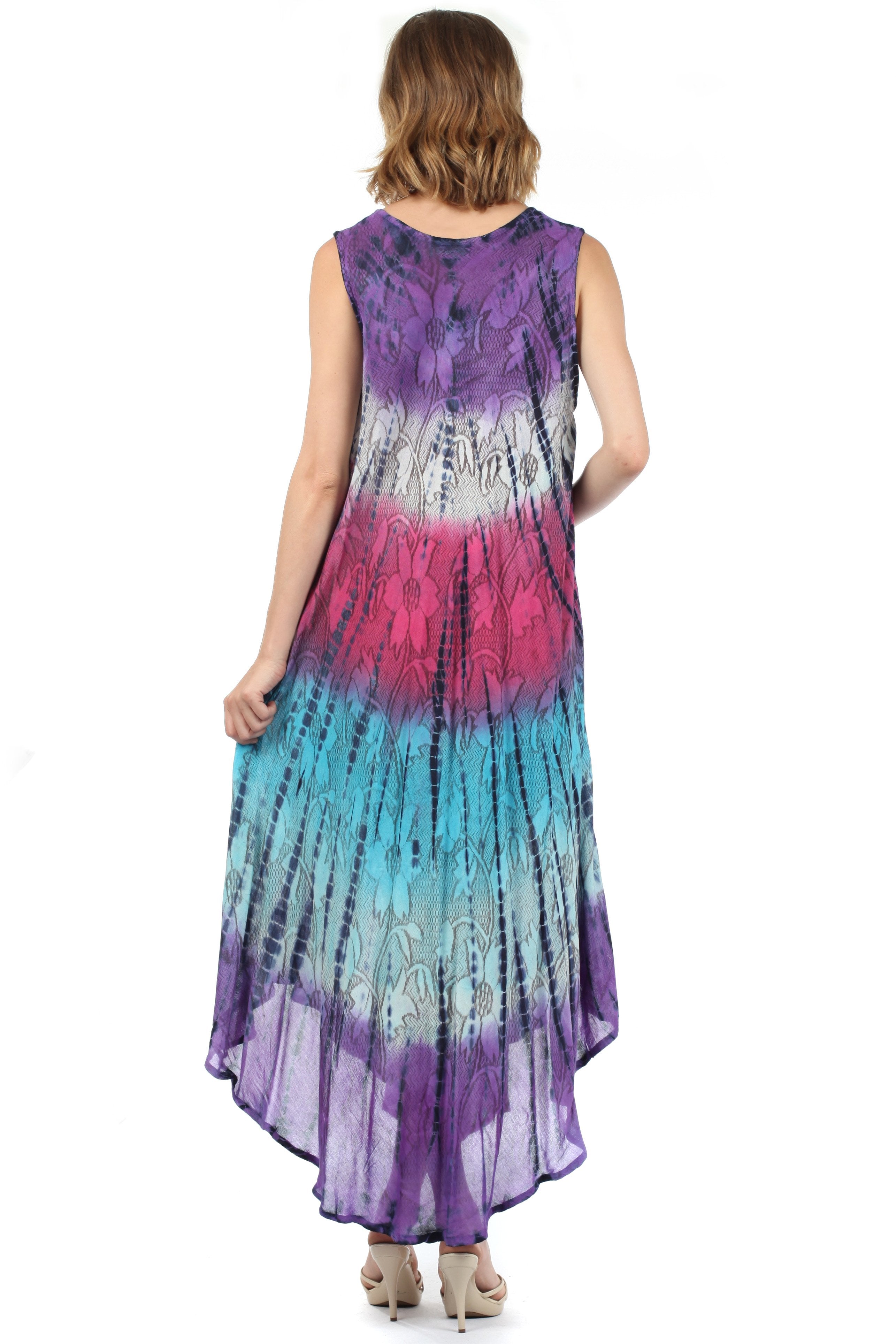Woman wearing a tie-dye dress with a gradient of purple, pink, and blue on a white background.