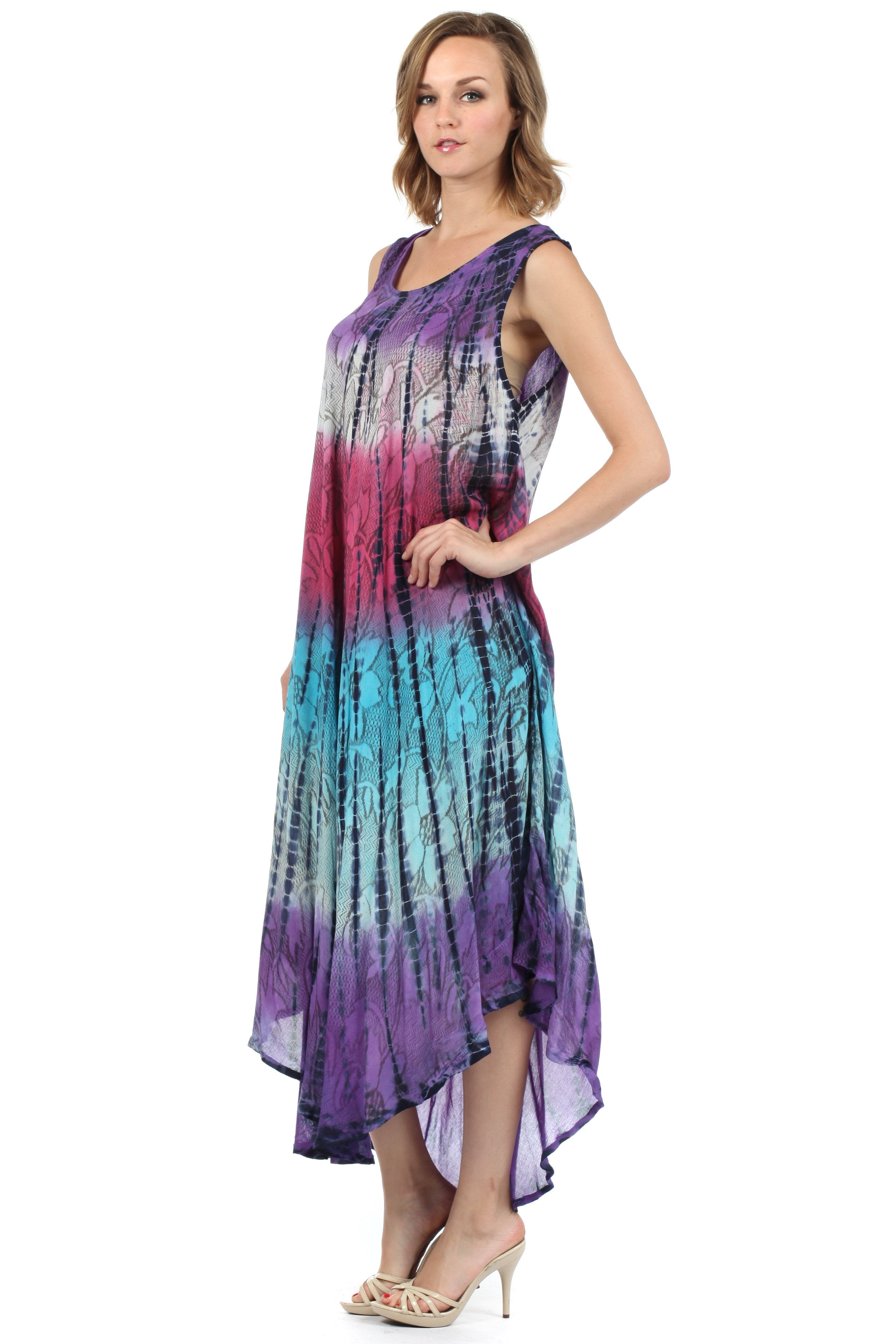 Woman wearing a tie-dye dress with a gradient of purple, blue, and black on a white background.