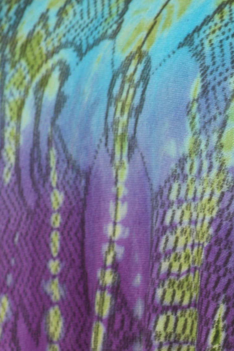 Close-up of a colorful tie-dye pattern with purple, green, and blue hues.
