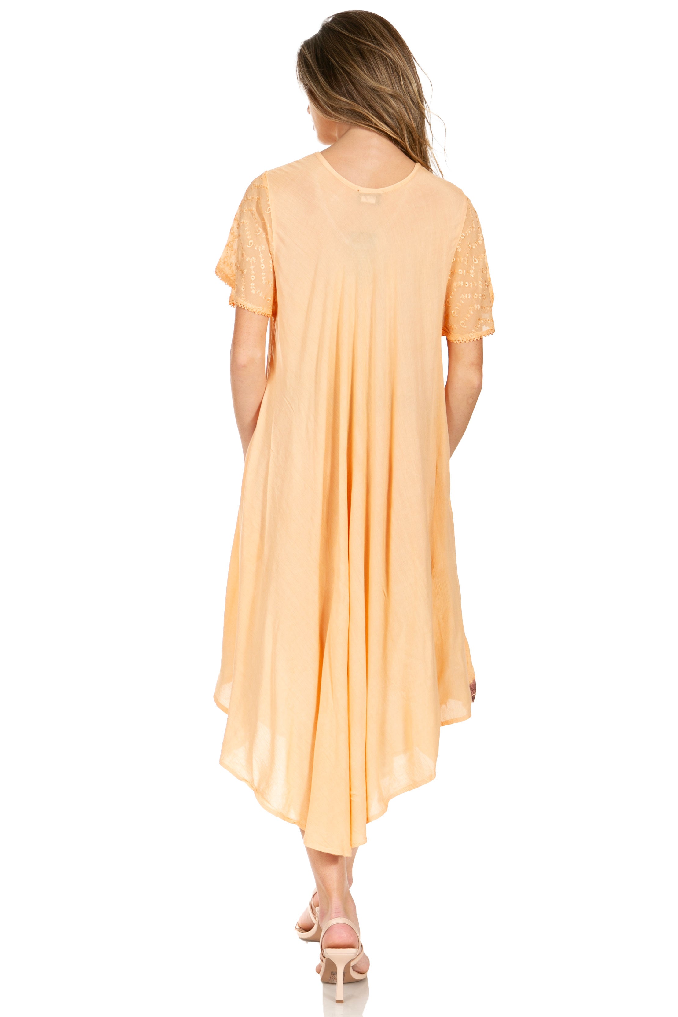 Woman wearing a peach-colored dress on a white background