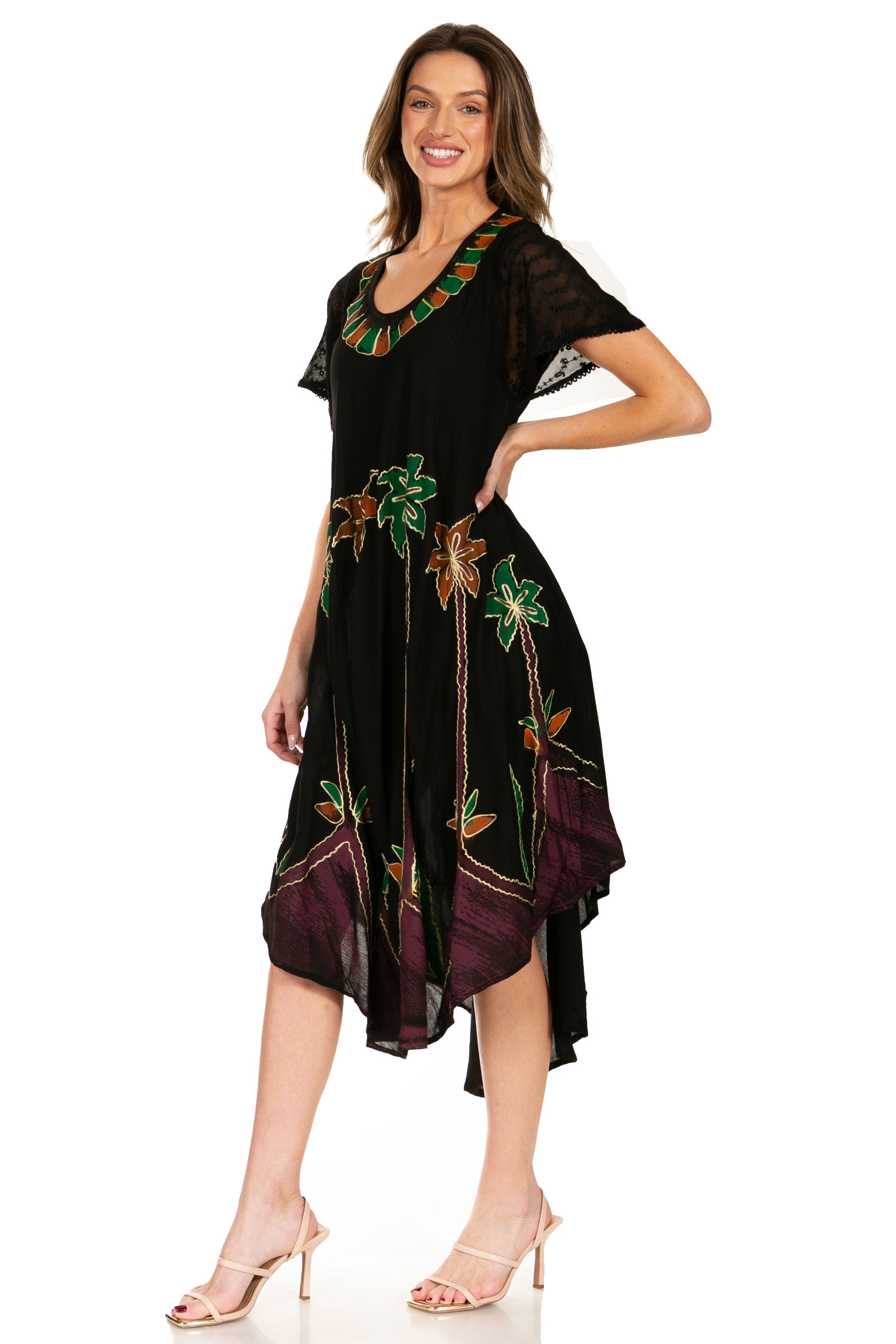 Woman wearing a black dress with floral embroidery on a white background