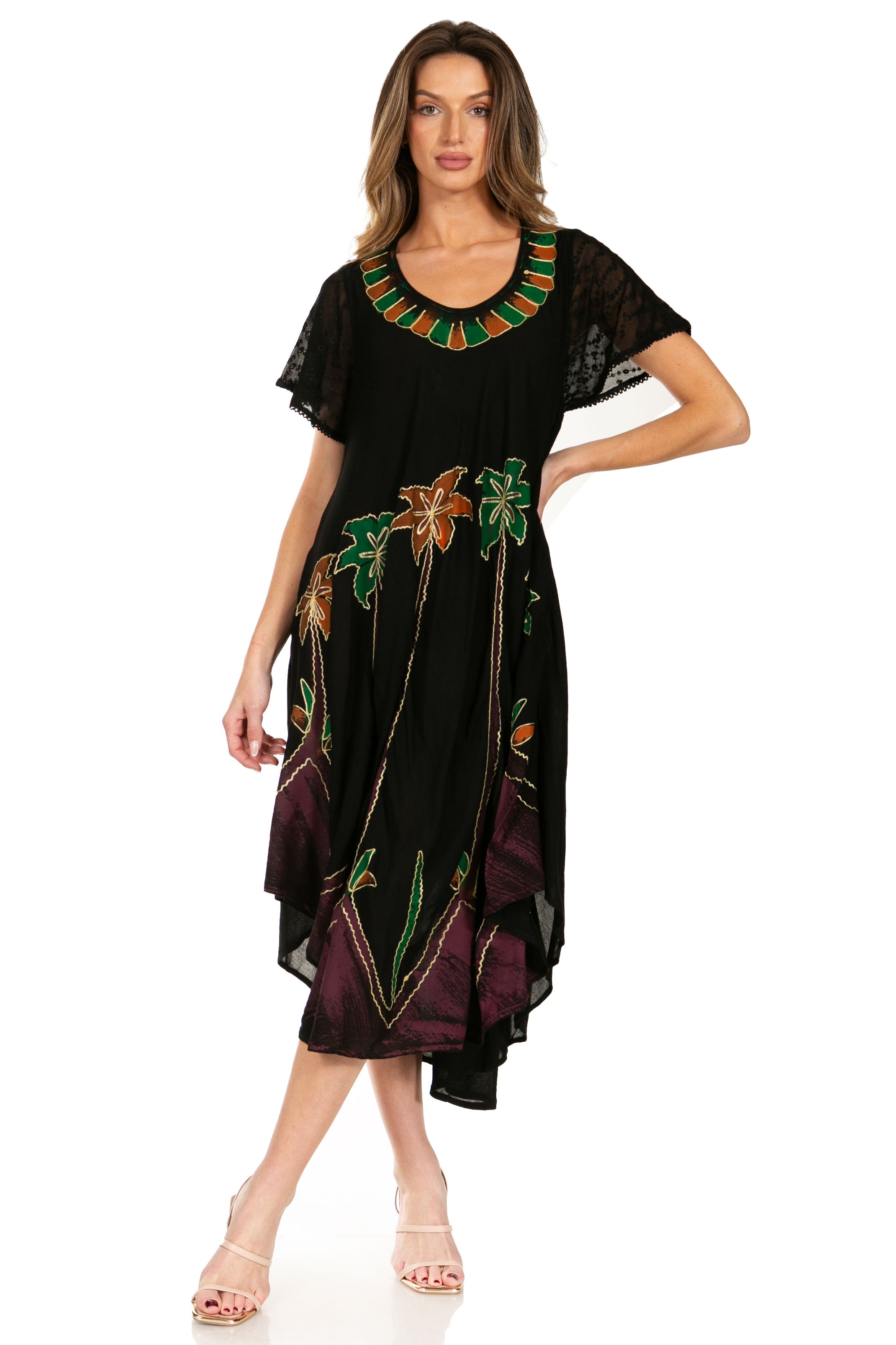 Woman wearing a black dress with colorful embroidery on a white background