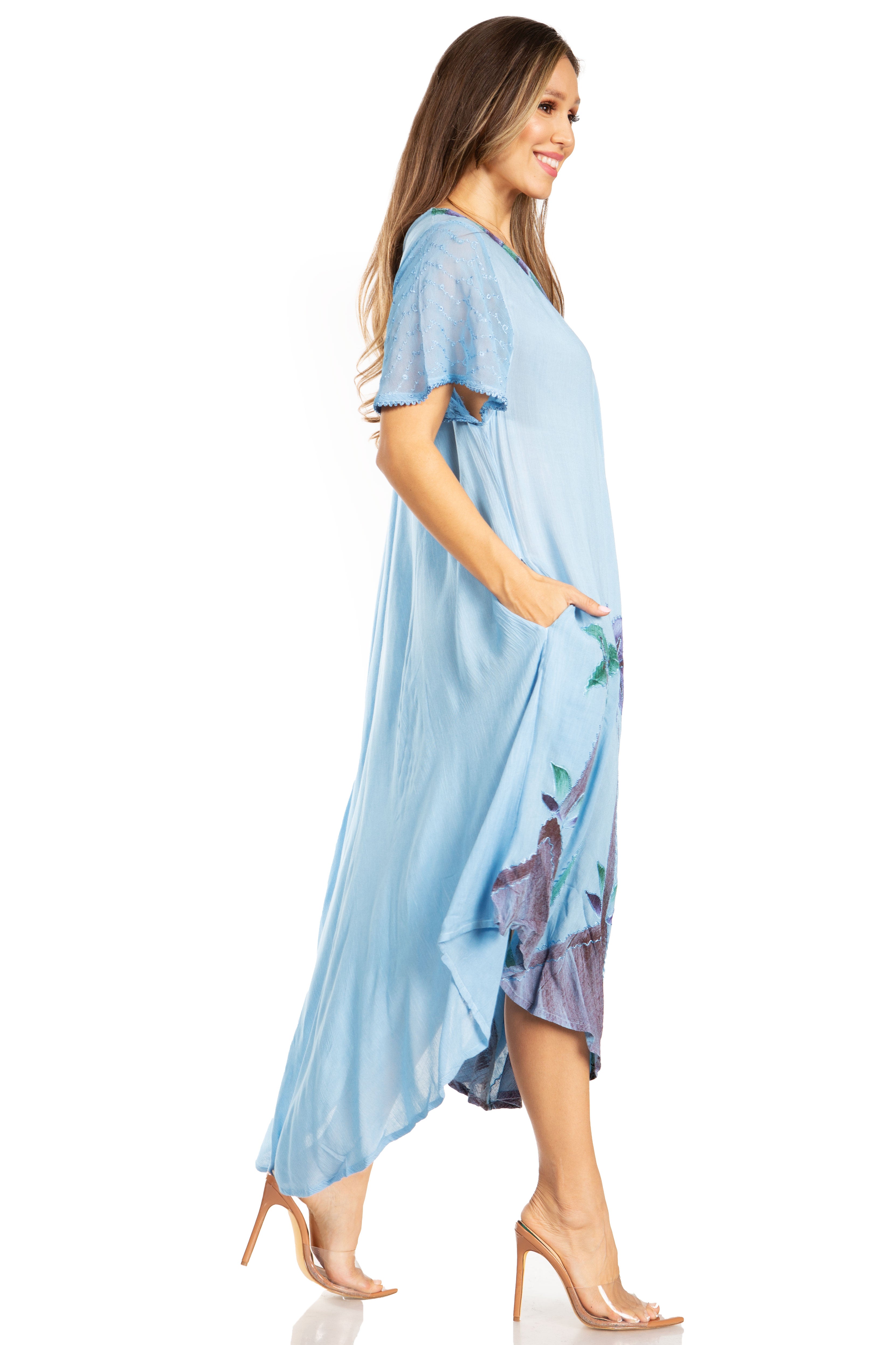 Woman wearing a light blue dress with floral patterns on a white background