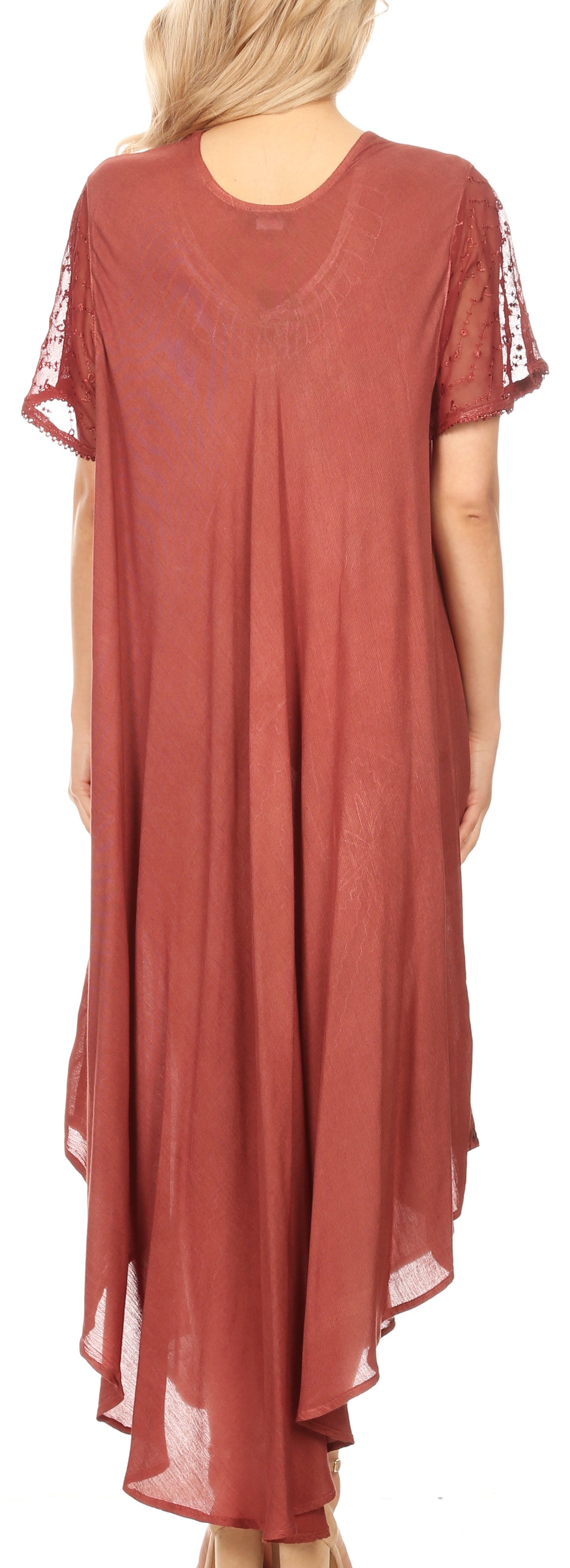 Rust-colored dress with sheer sleeves worn by a person on a white background