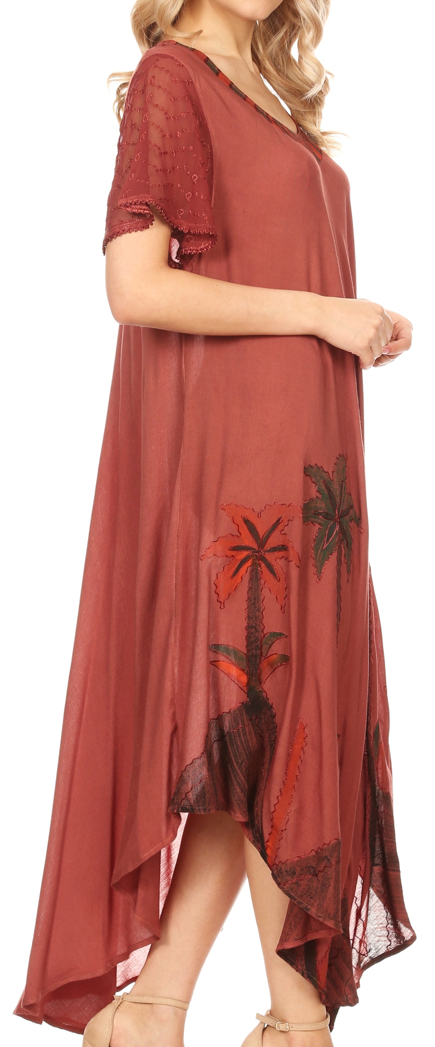 Long rust-colored dress with floral patterns on a white background