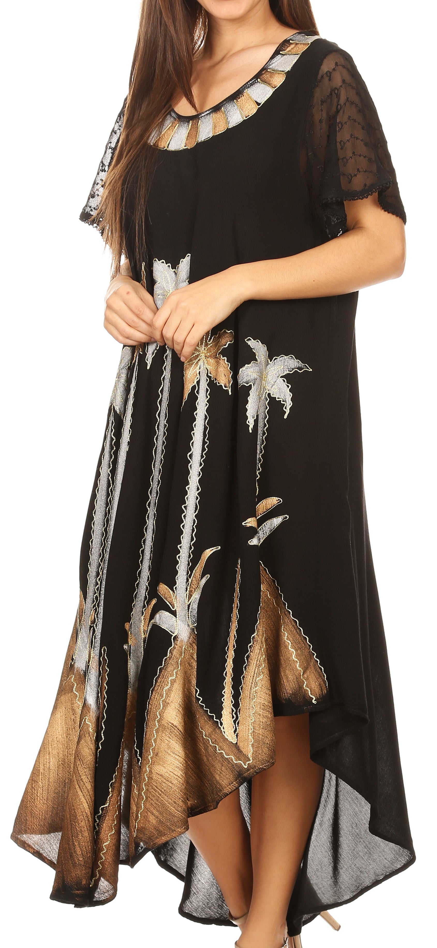 Woman wearing a black dress with gold and white floral patterns