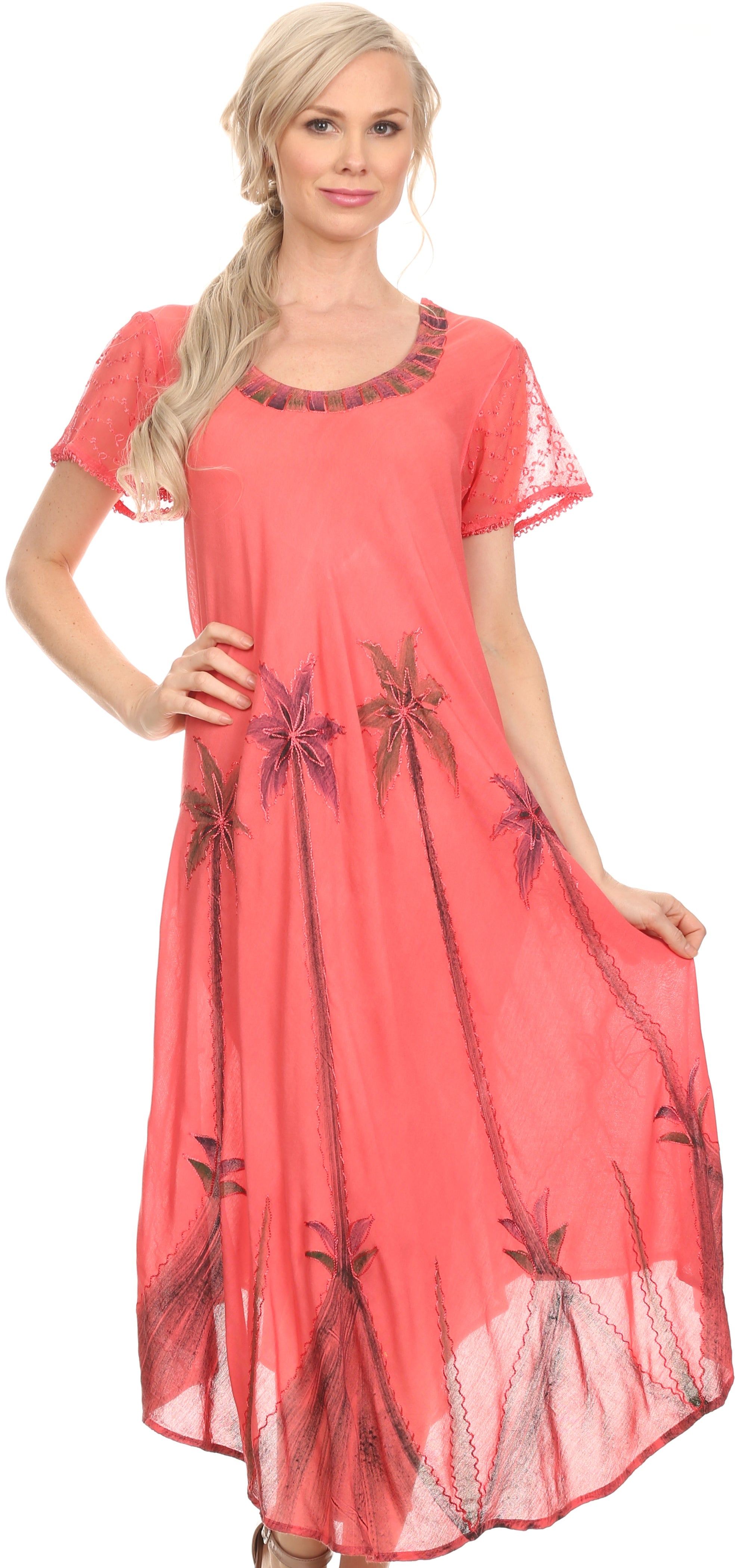 Woman wearing a coral dress with floral patterns on a white background