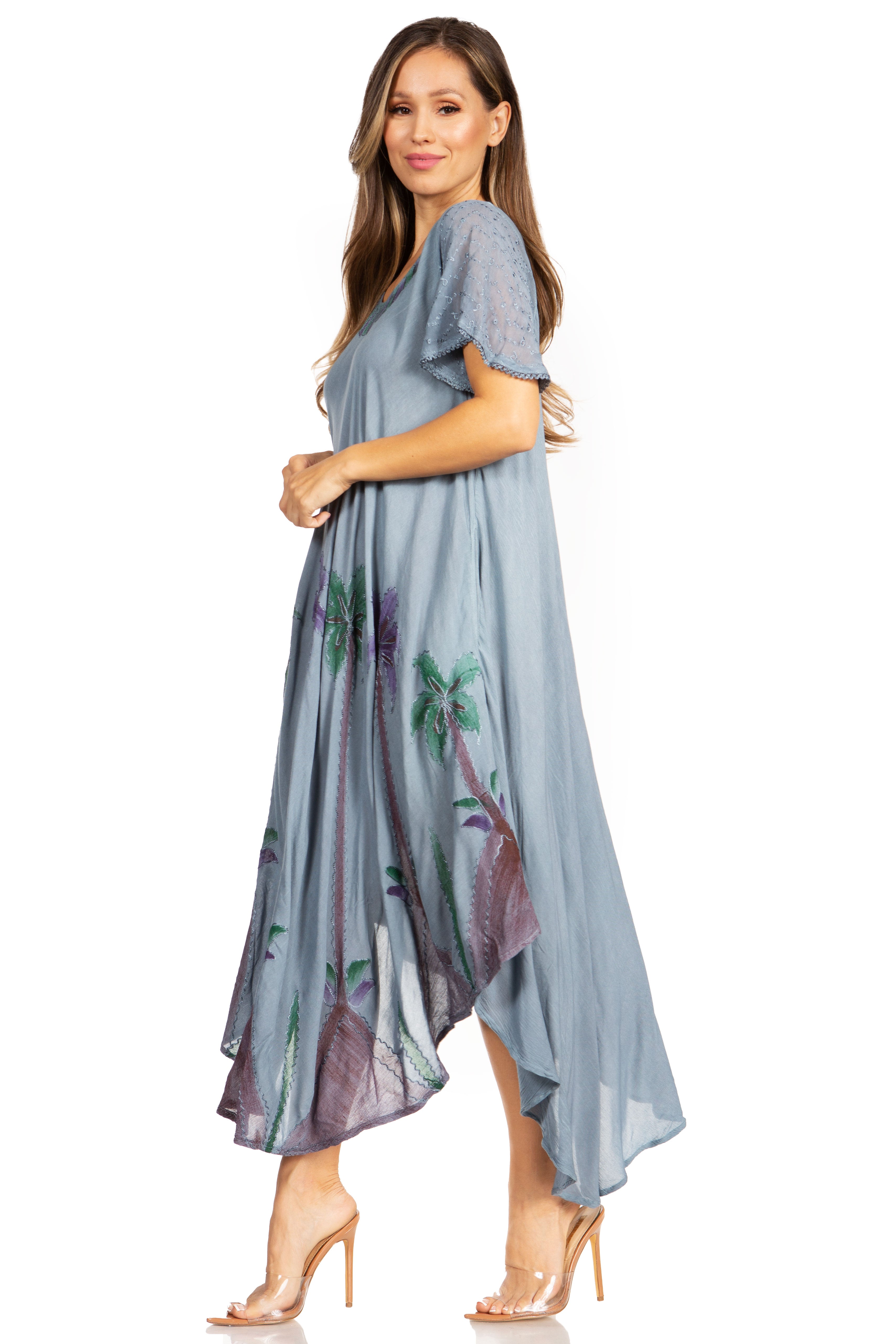 Woman wearing a light blue dress with floral patterns on a white background