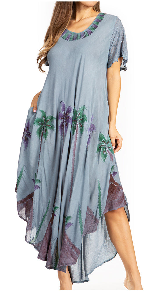 Woman wearing a gray dress with floral patterns on a white background