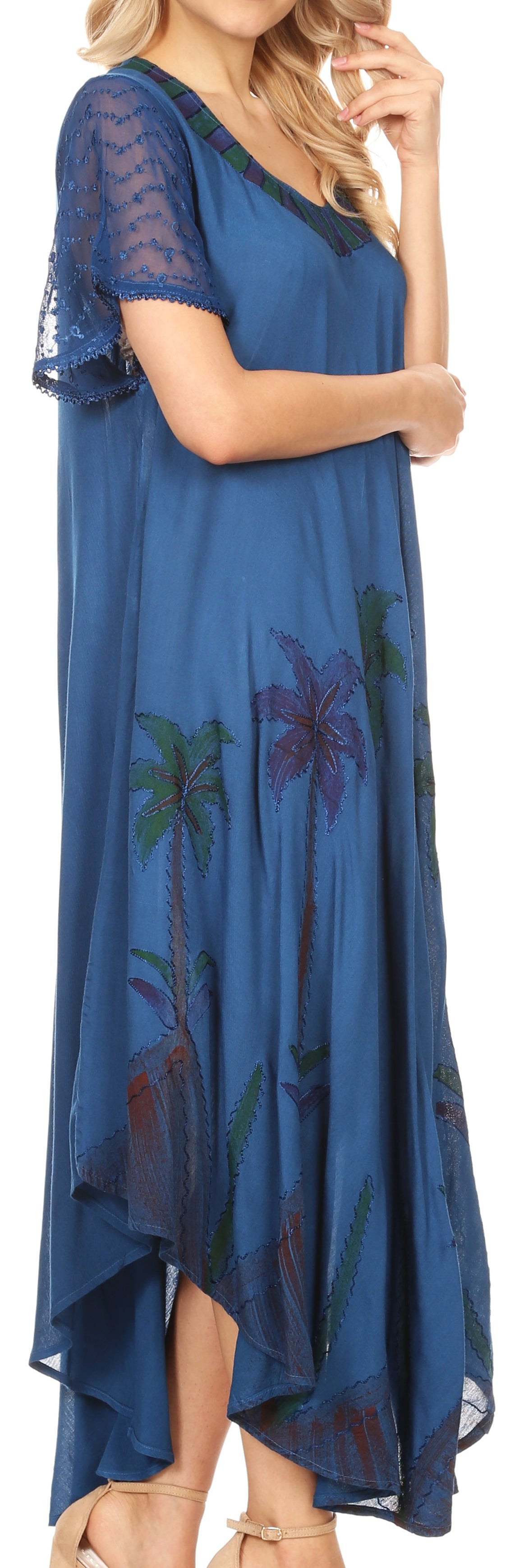 Woman wearing a blue dress with floral patterns on a white background
