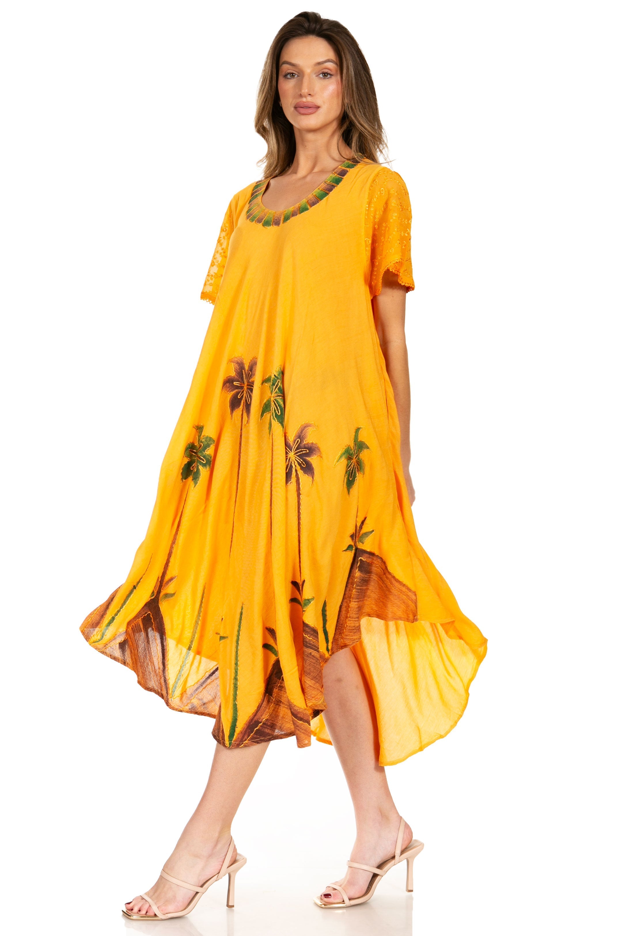 Woman wearing a yellow dress with floral patterns on a white background