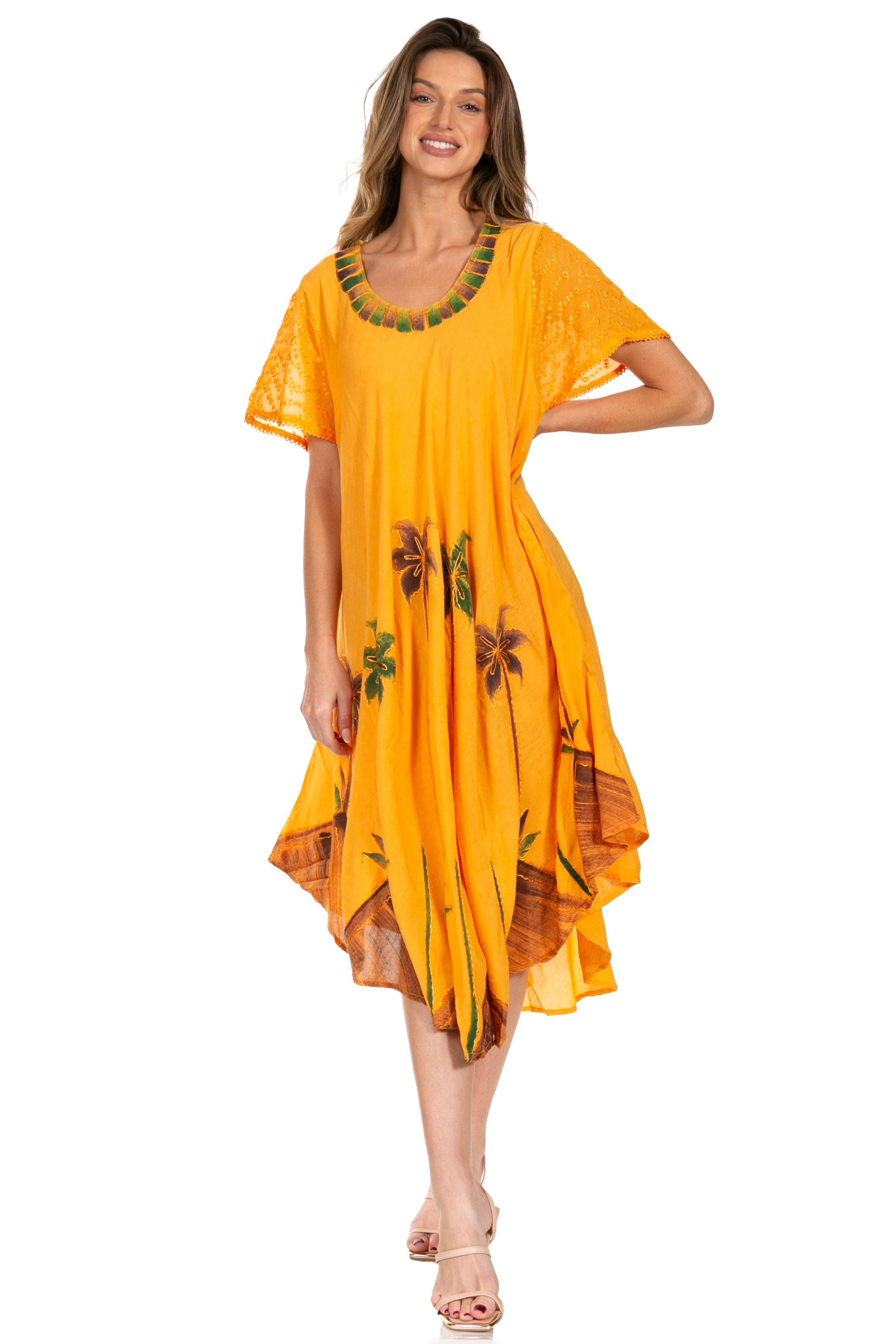 Woman wearing a yellow dress with floral patterns on a white background