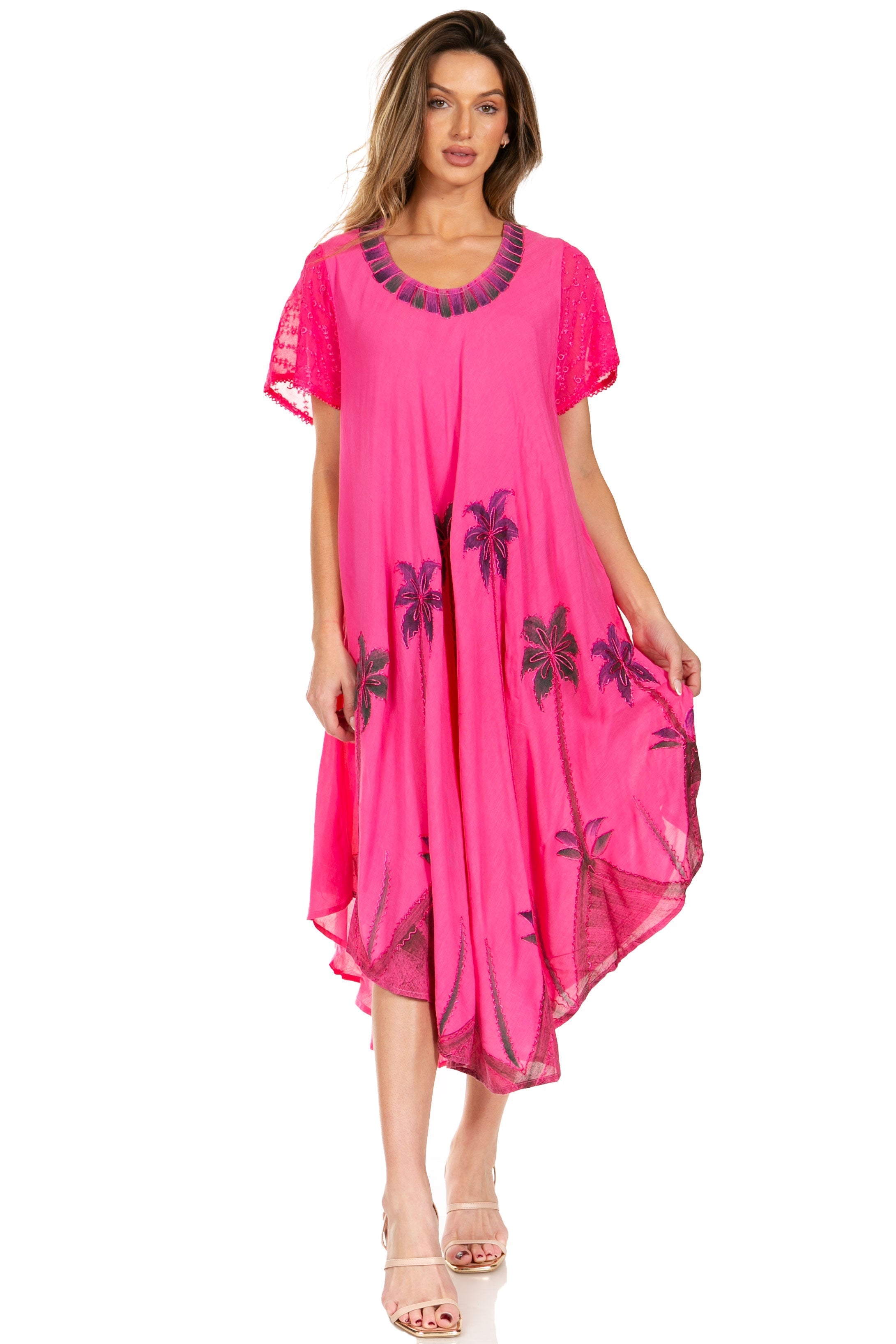 Woman wearing a pink dress with floral patterns on a white background