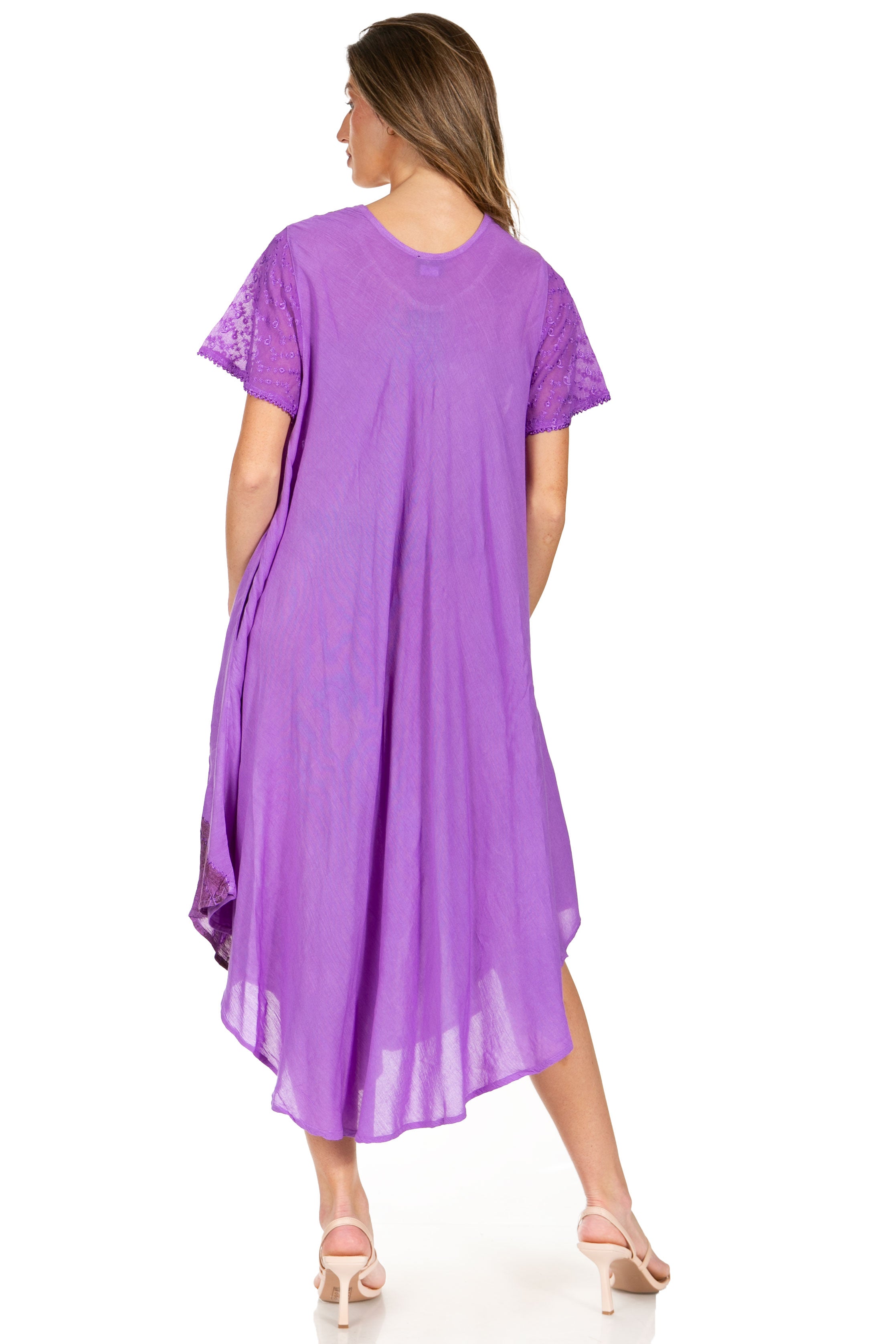 Woman wearing a purple dress with lace sleeves on a white background