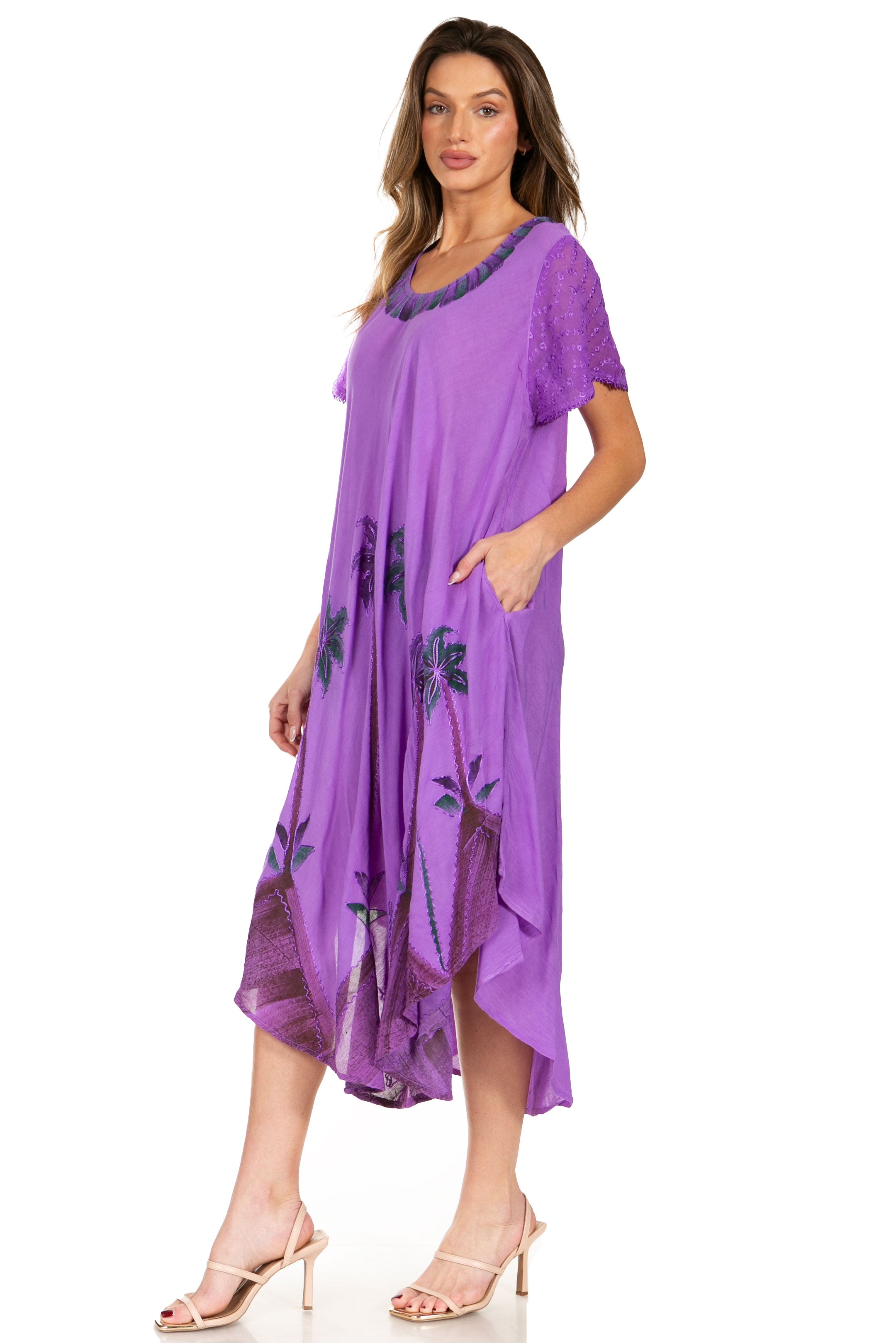 Woman wearing a purple dress with floral patterns on a white background