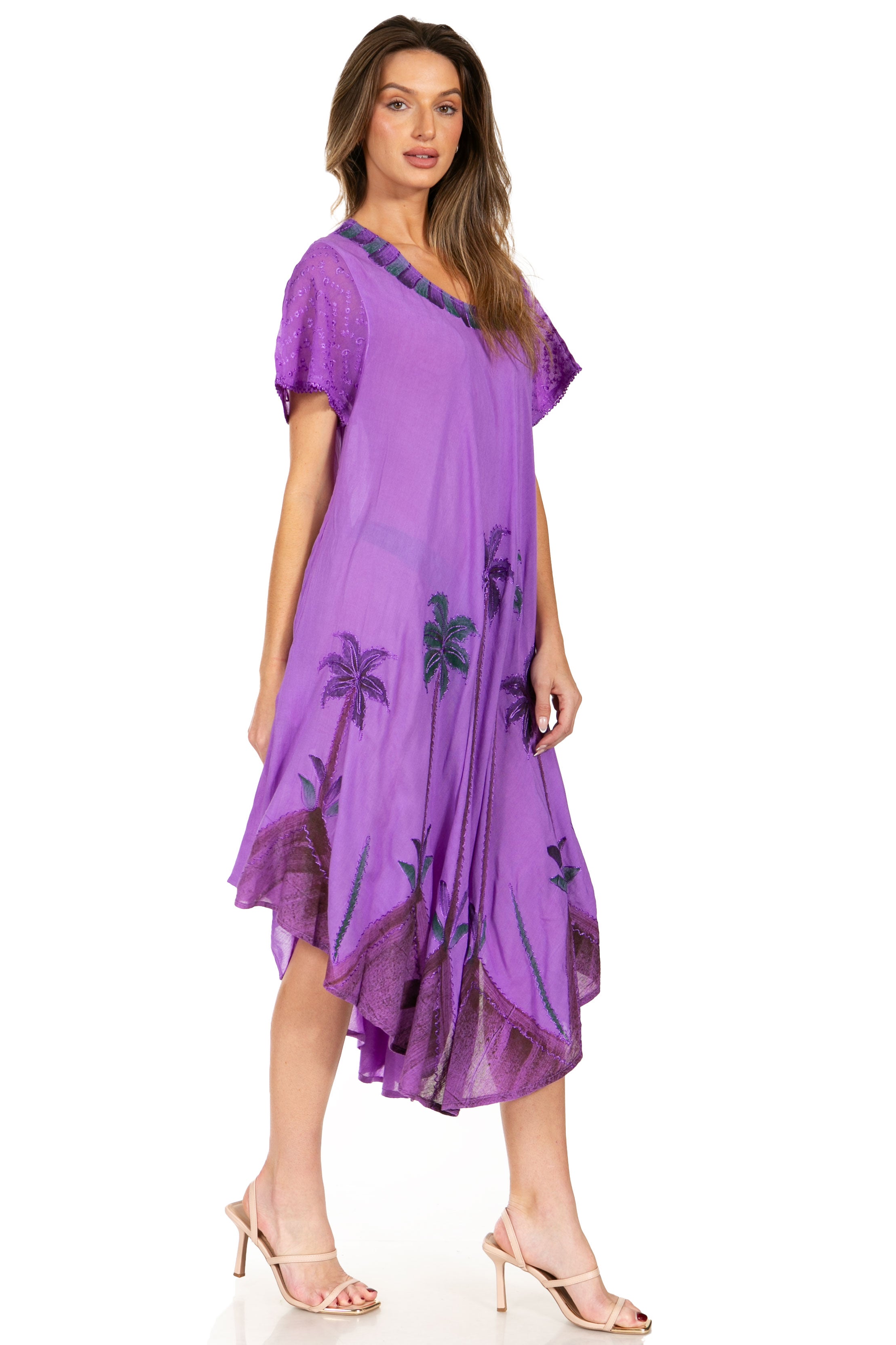 Woman wearing a purple dress with floral patterns on a white background