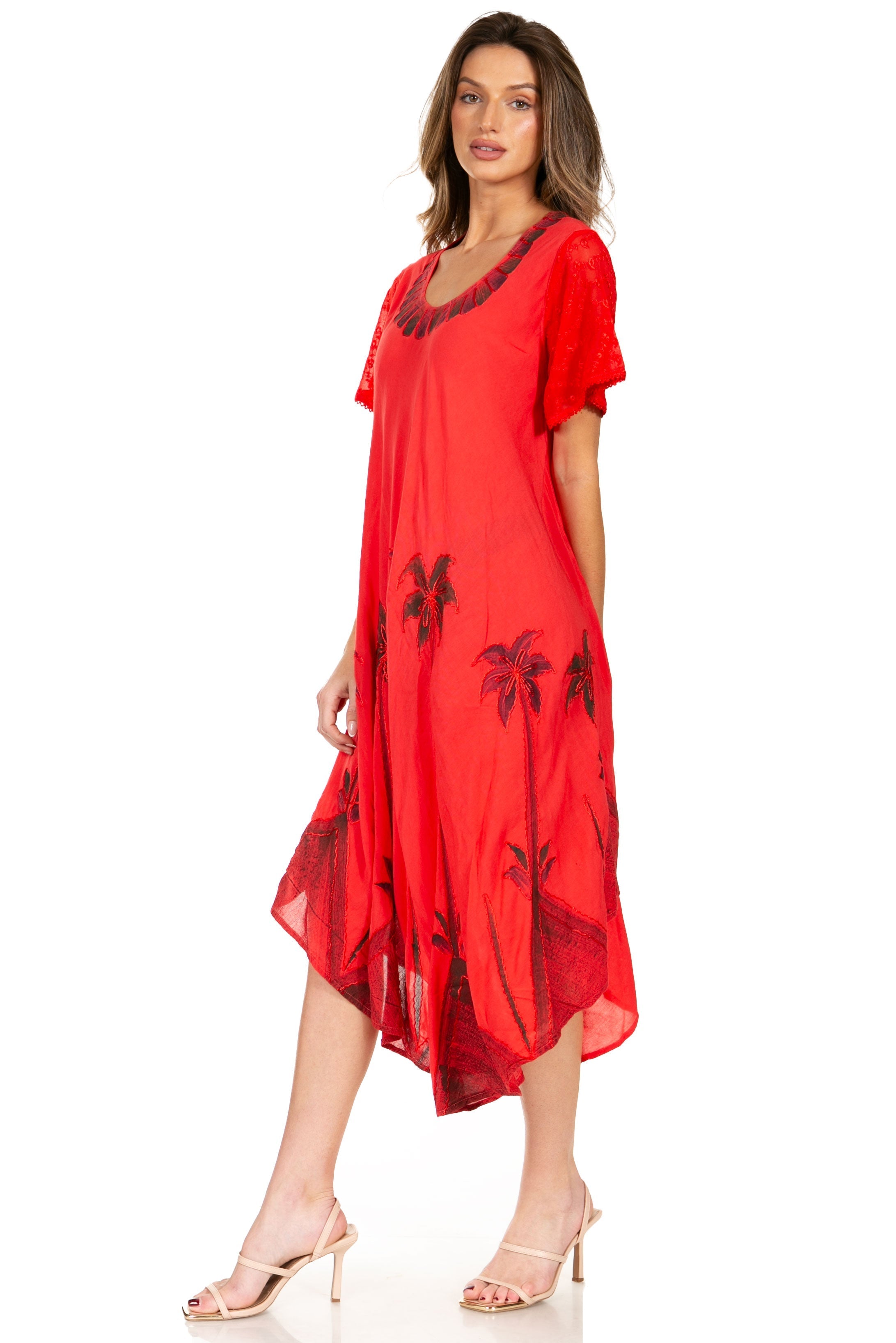 Woman wearing a red dress with black floral patterns on a white background