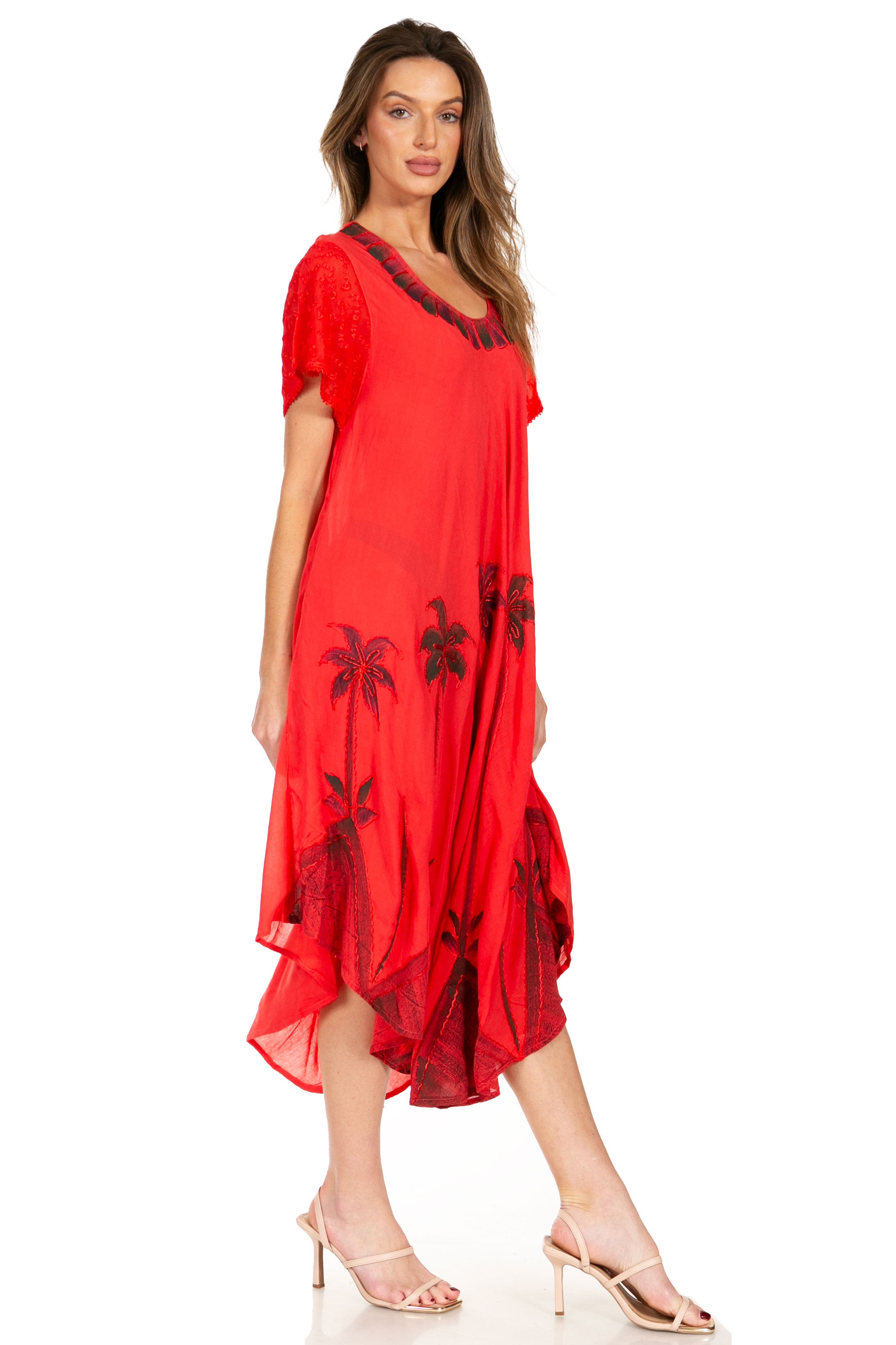 Woman wearing a red dress with black palm tree patterns on a white background