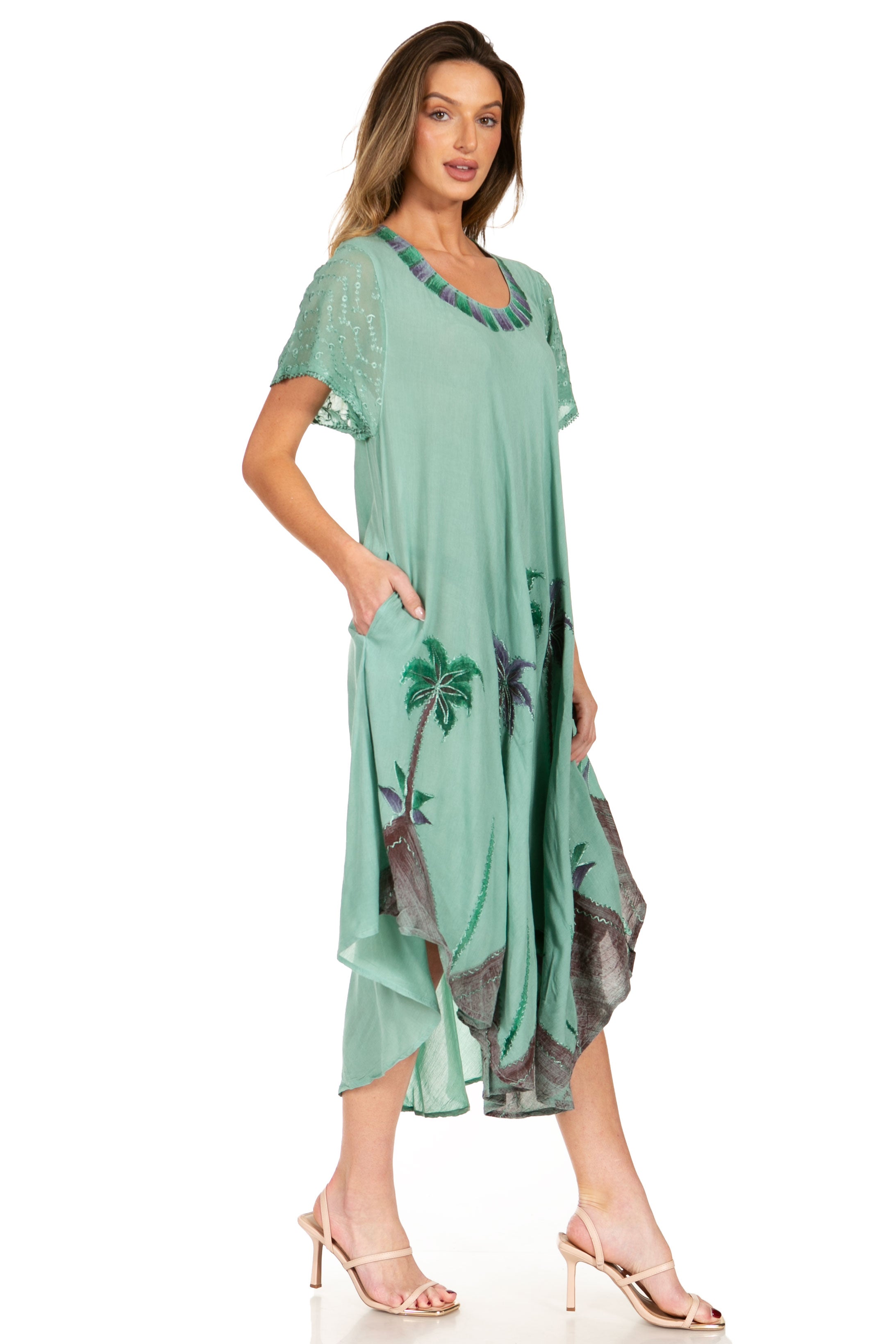 Woman wearing a green dress with palm tree design on a white background