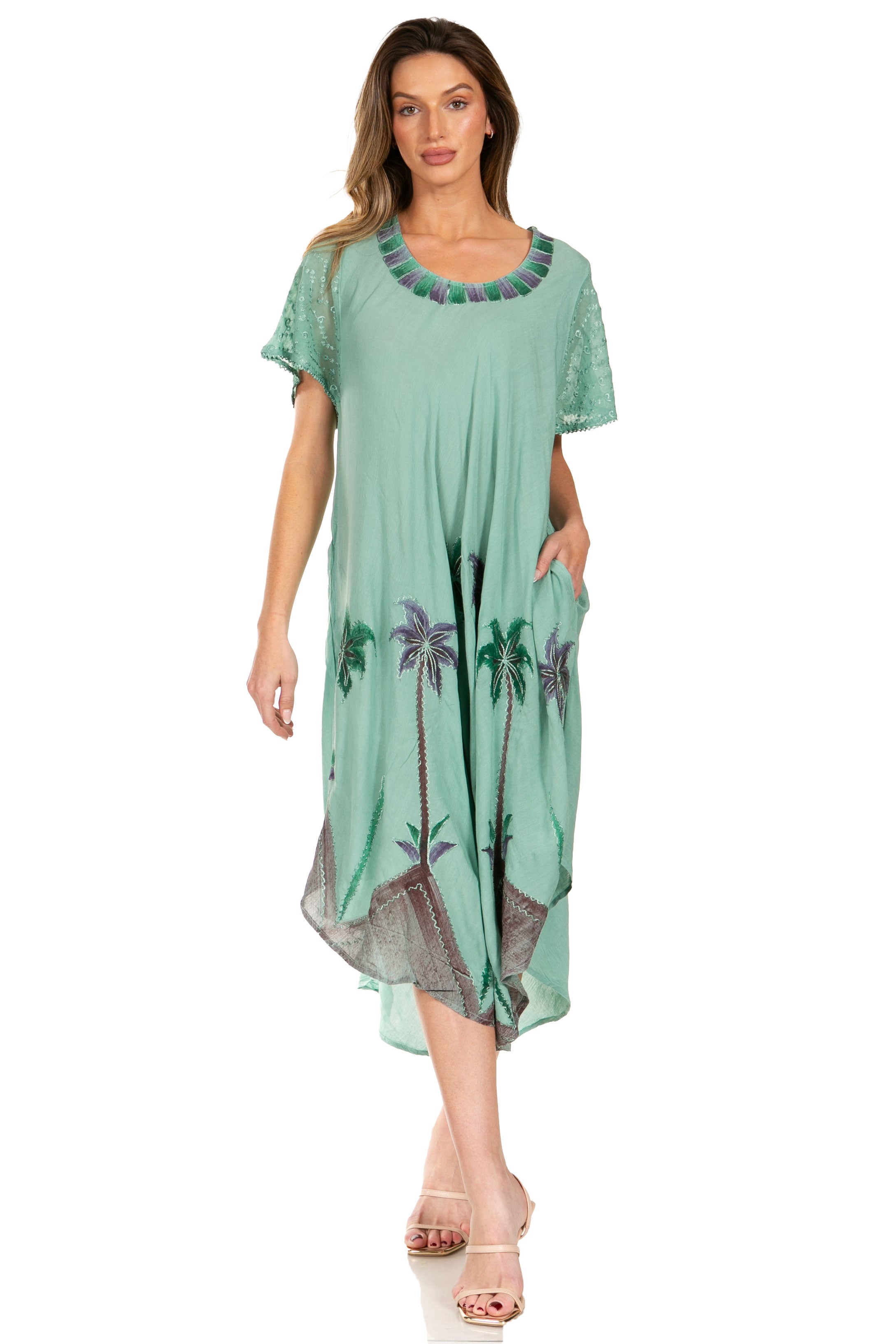 Woman wearing a green dress with palm tree design on a white background