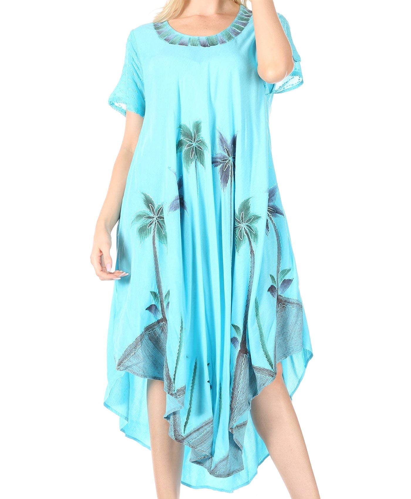 Light blue dress with palm tree pattern worn by a model on a white background