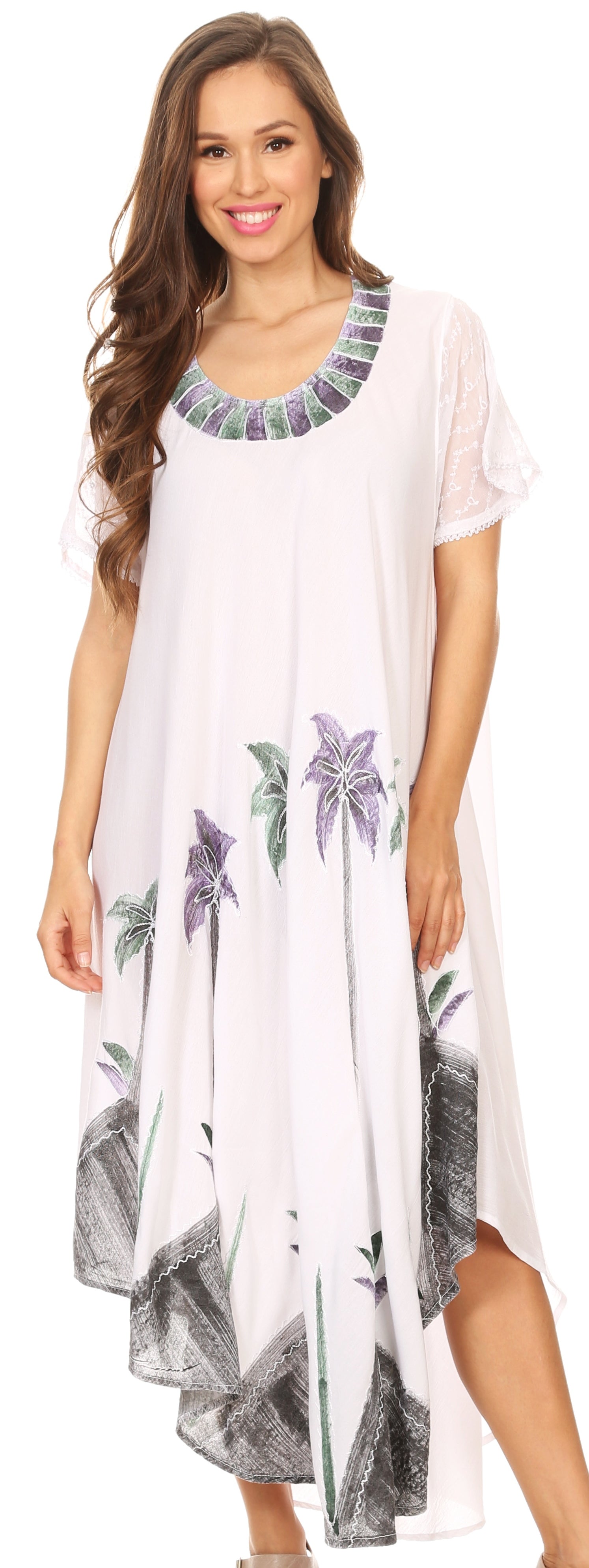 Woman wearing a white dress with floral patterns on a plain background