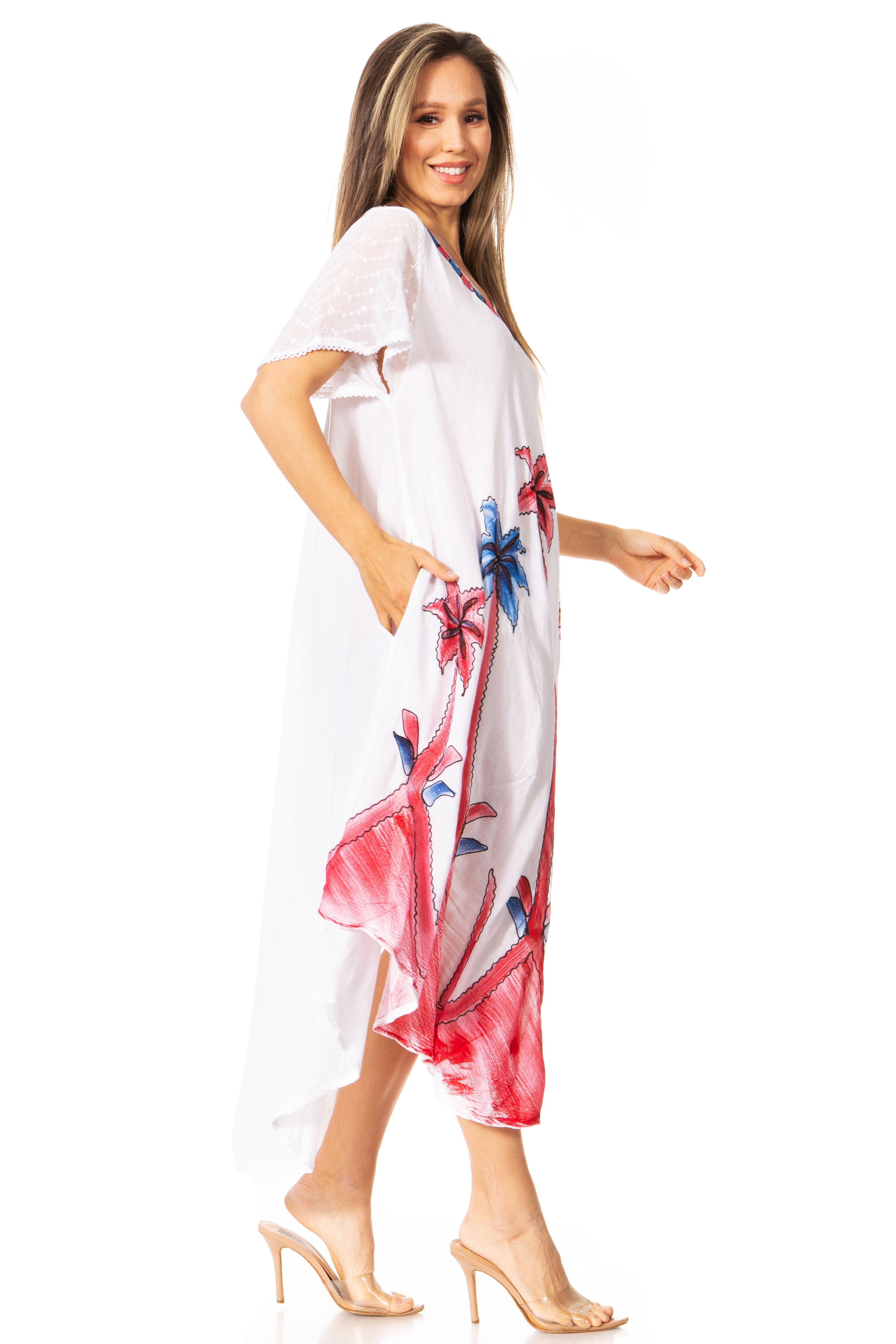 Woman wearing a white dress with colorful floral patterns on a white background