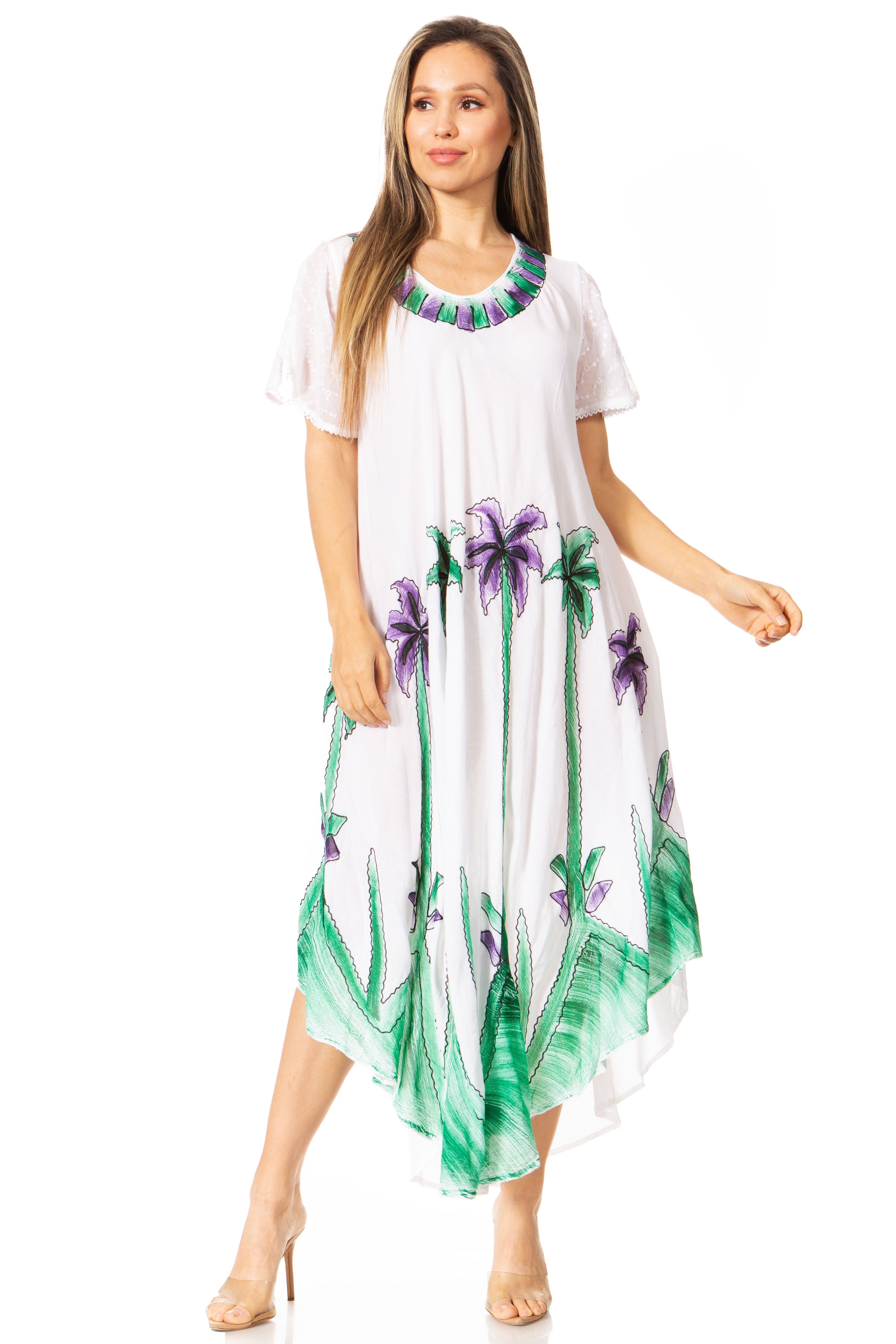 Woman wearing a white dress with green and purple floral patterns on a white background