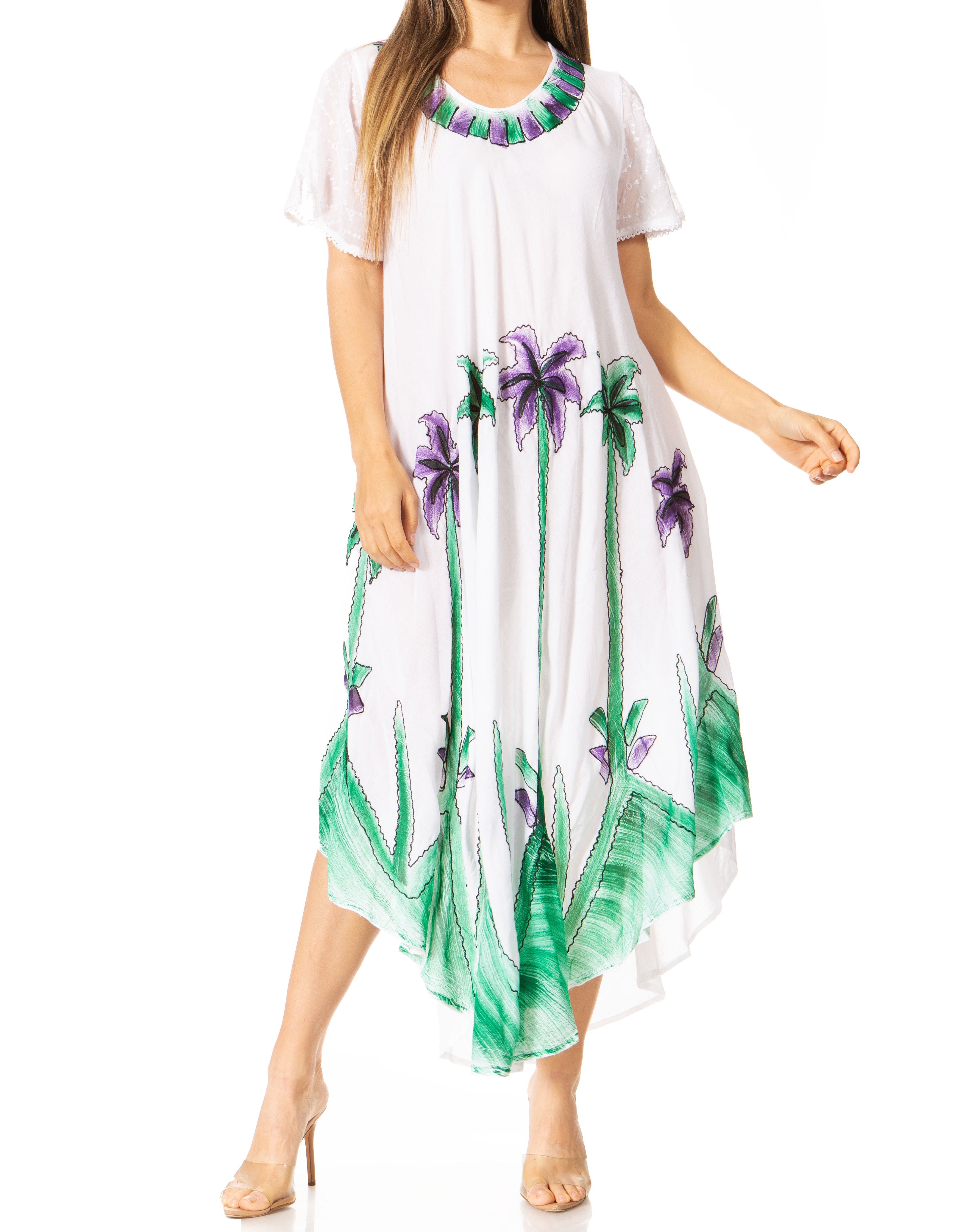 Woman wearing a white dress with green and purple floral patterns on a white background