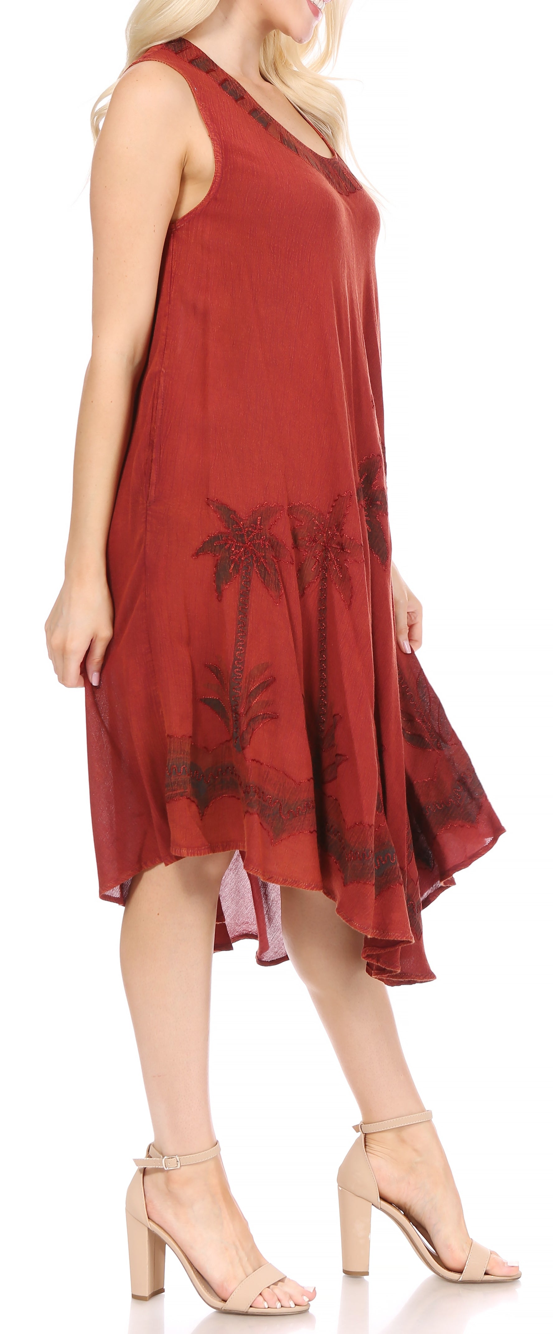 Red dress with palm tree pattern worn by a model on a white background