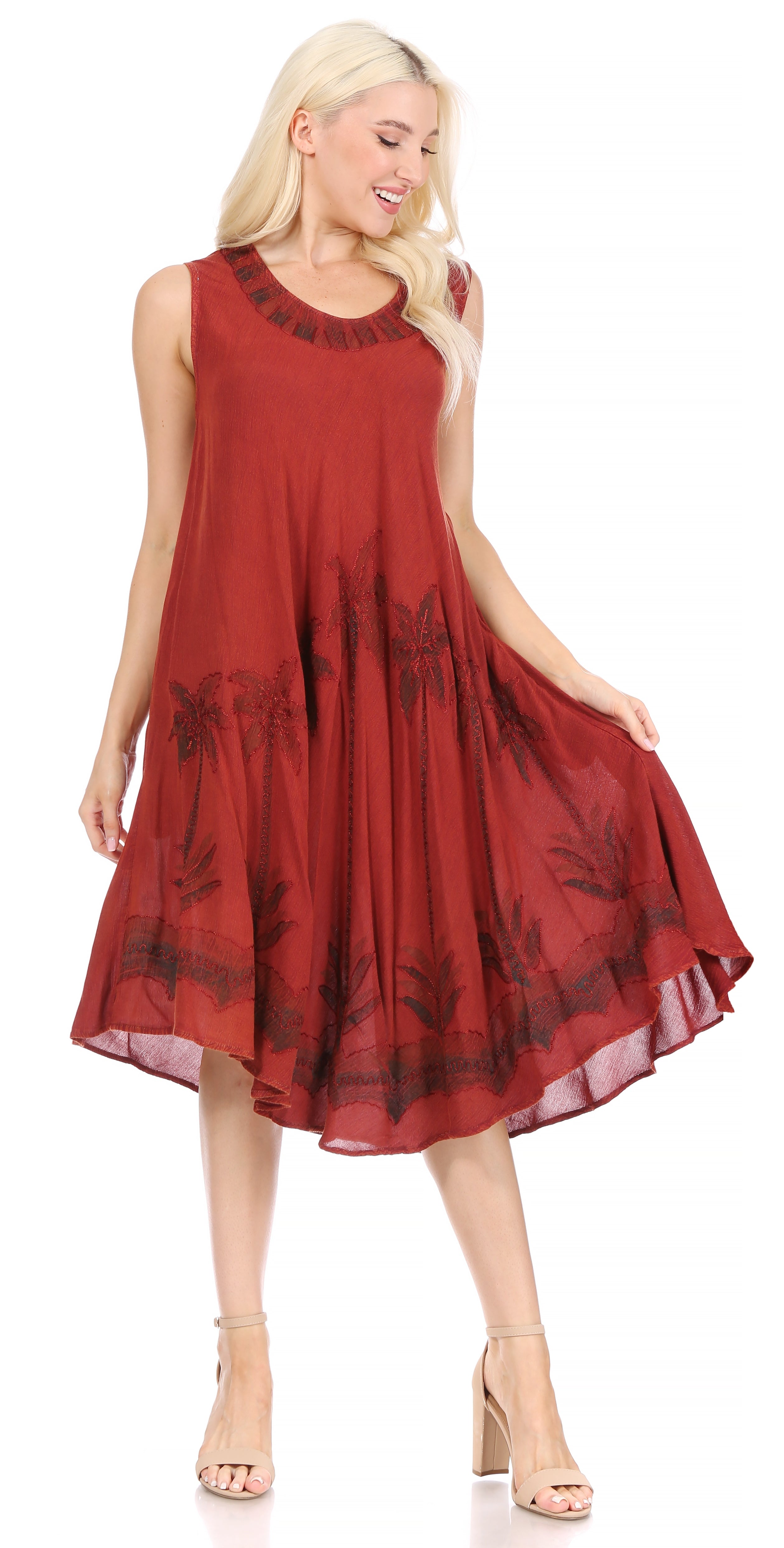 Woman wearing a red dress with black floral patterns on a white background
