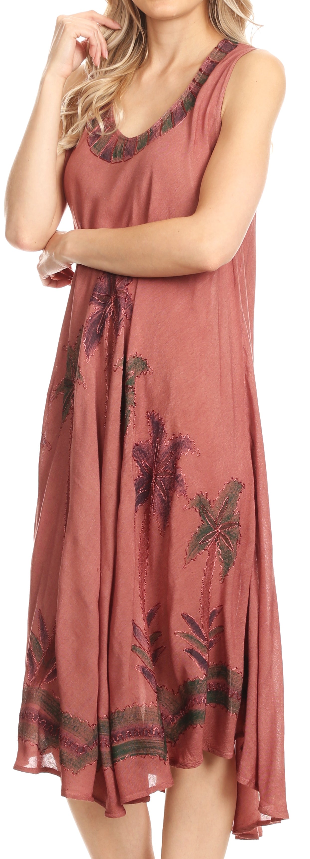 Woman wearing a rust-colored dress with floral patterns