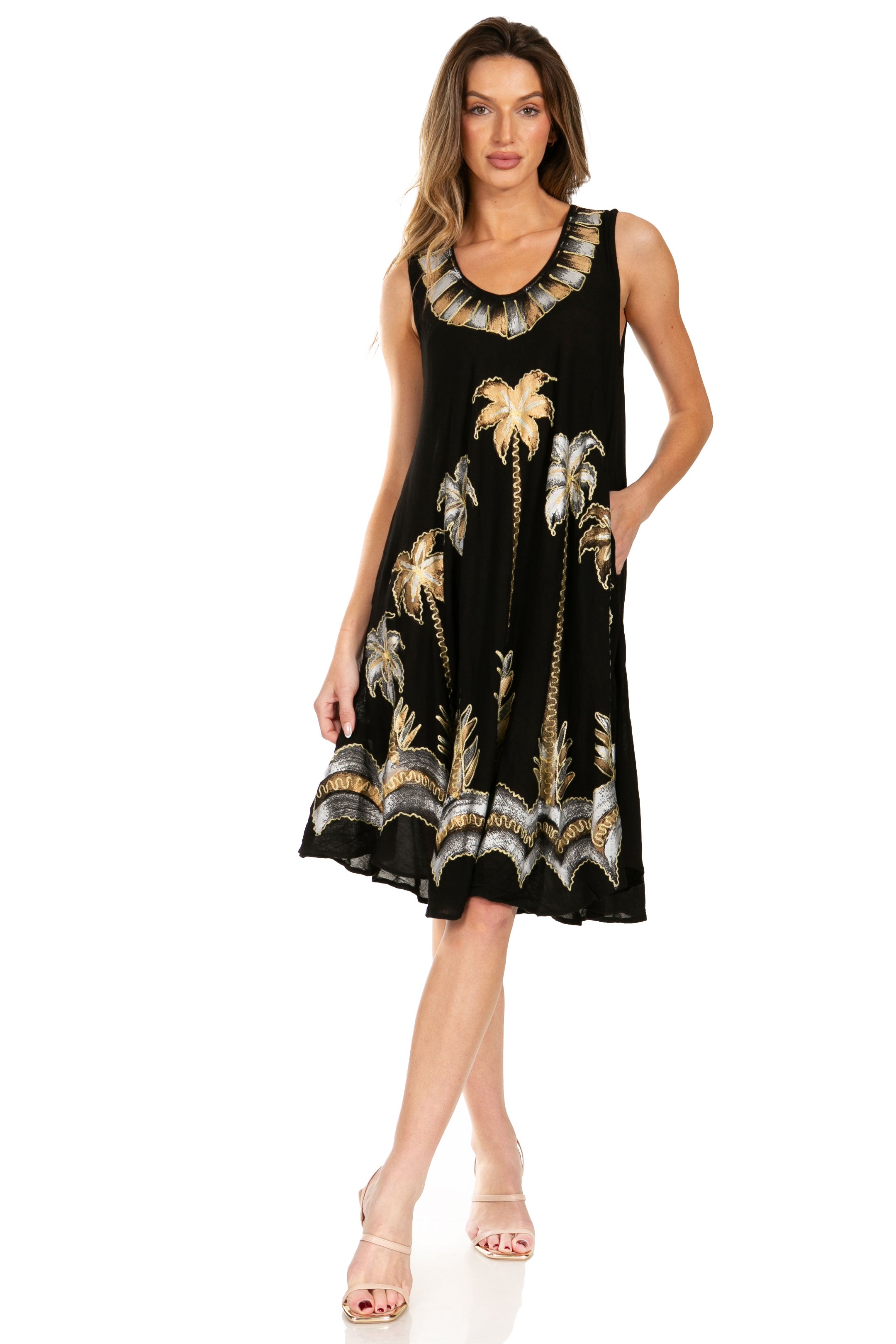 Woman wearing a black dress with gold palm tree pattern on a white background