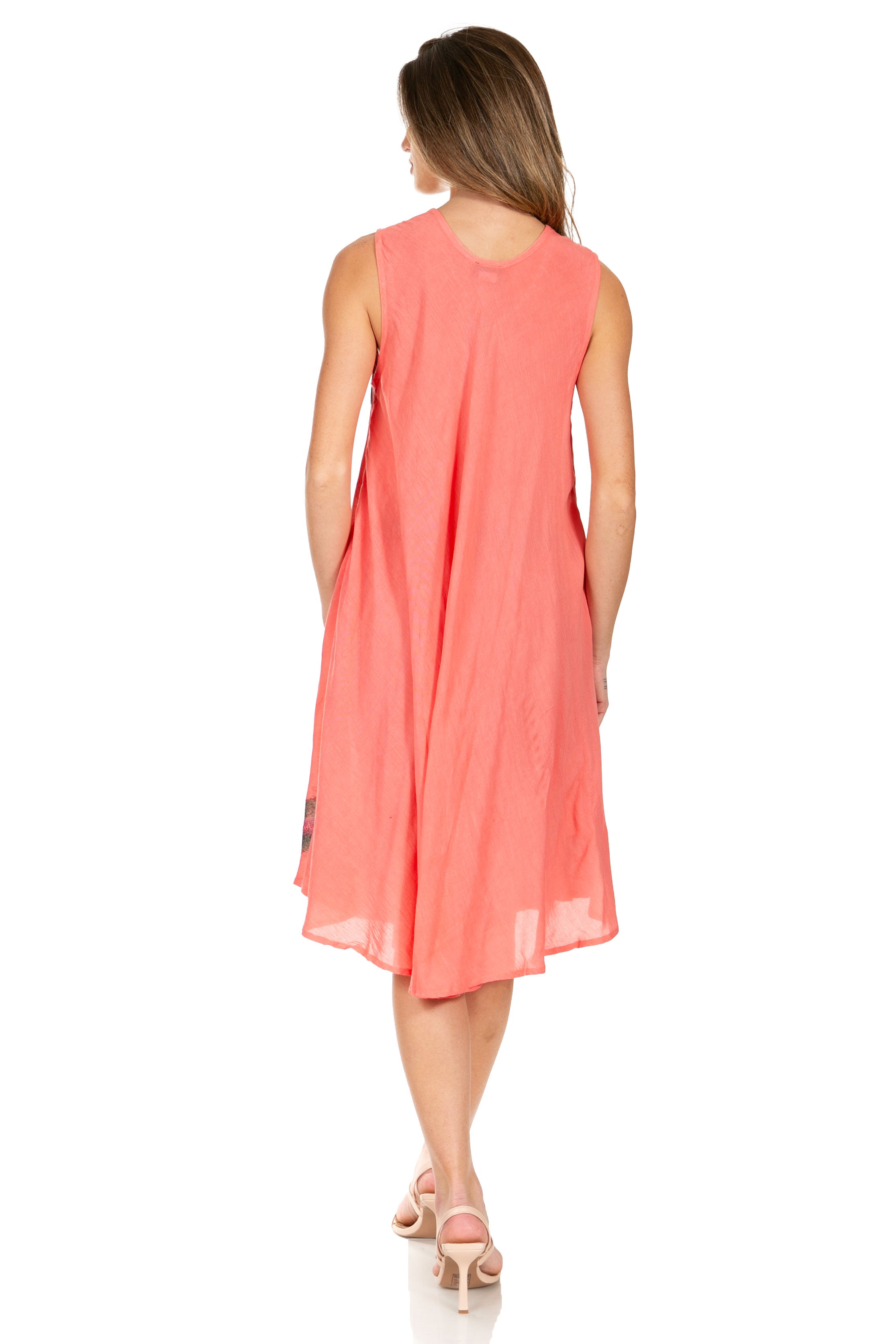 Woman wearing a coral dress on a white background
