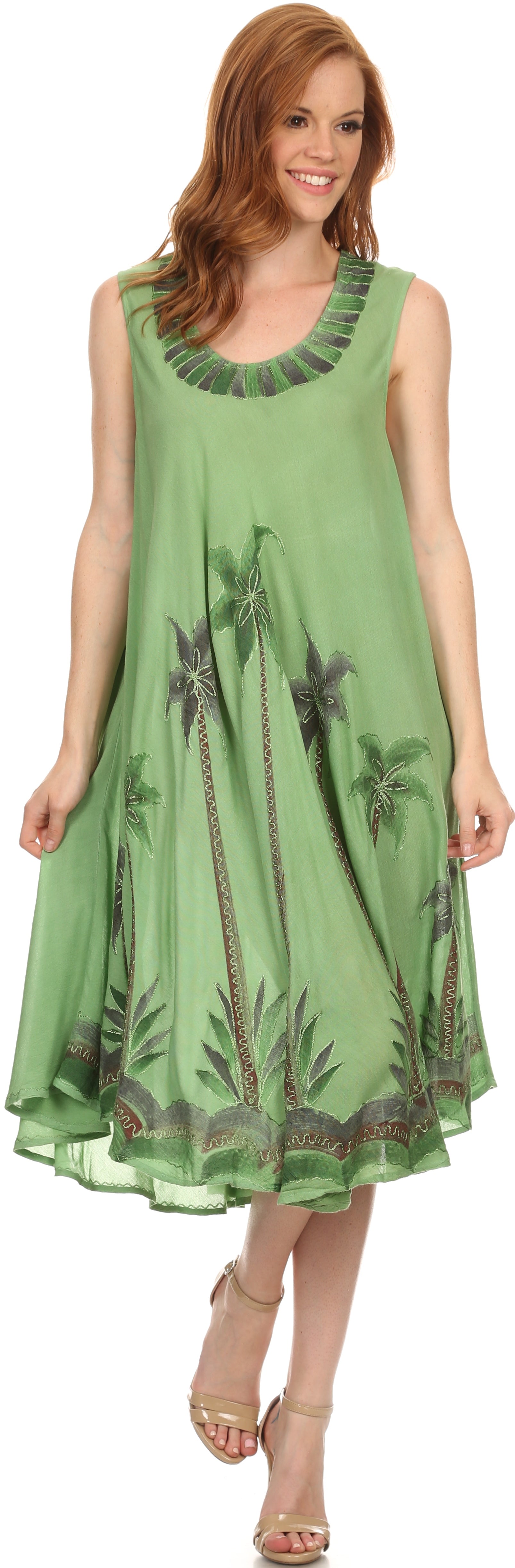 Woman wearing a green dress with palm tree design on a white background