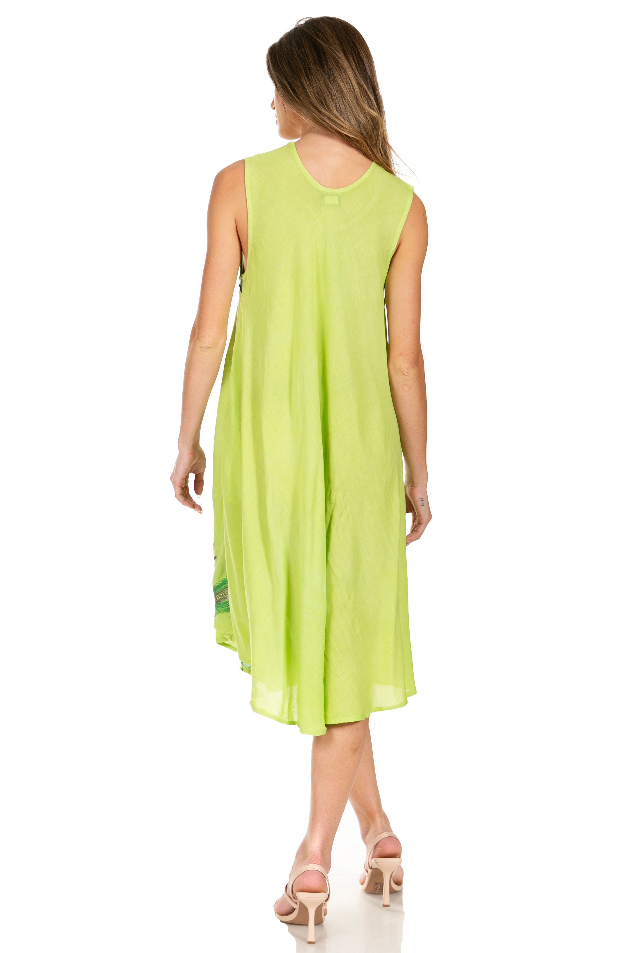 Woman wearing a light green sleeveless dress on a white background