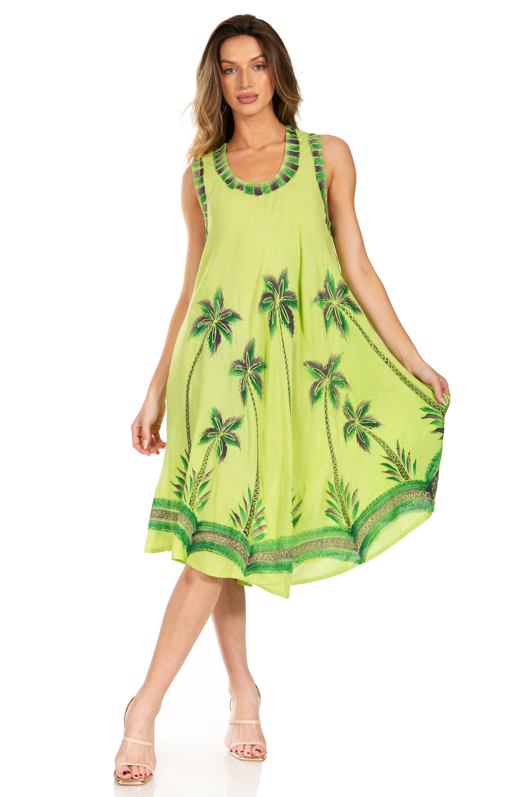 Woman wearing a bright green dress with palm tree patterns on a white background