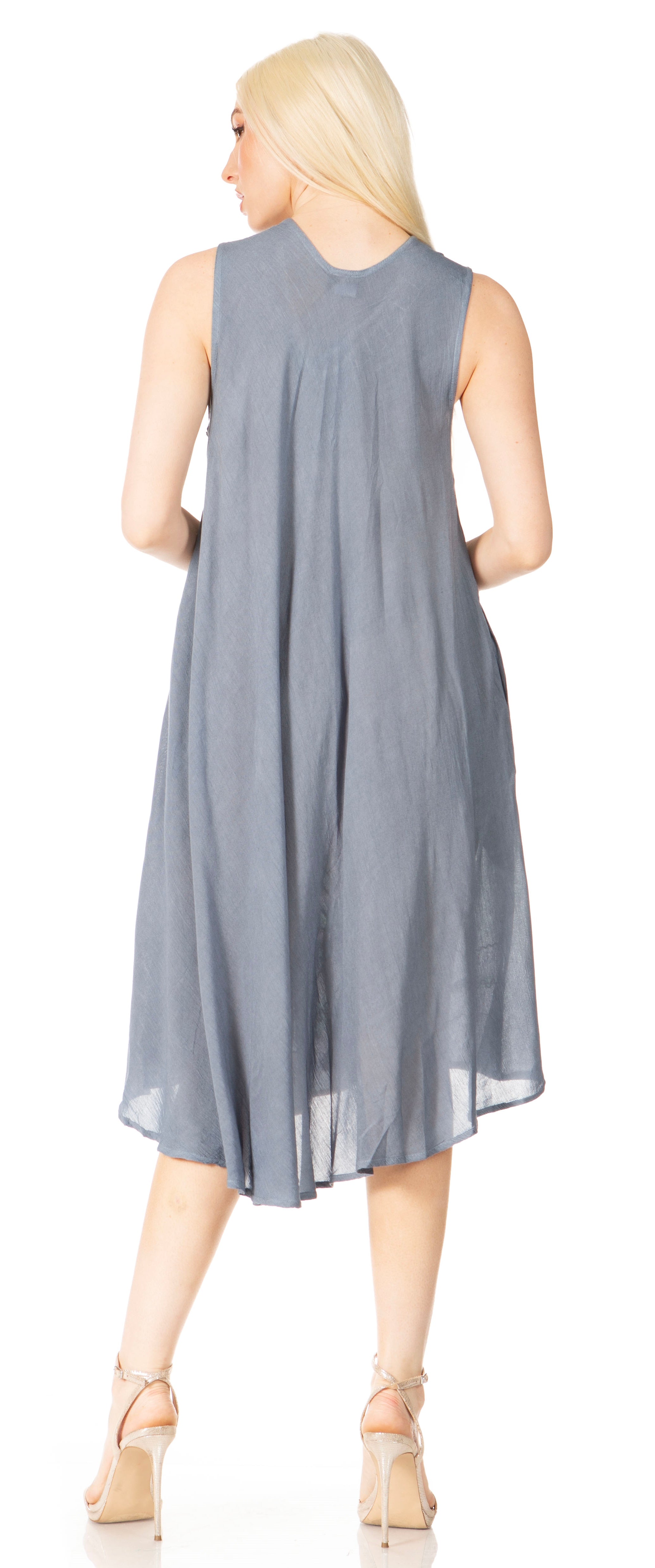 Woman wearing a sleeveless gray dress on a white background